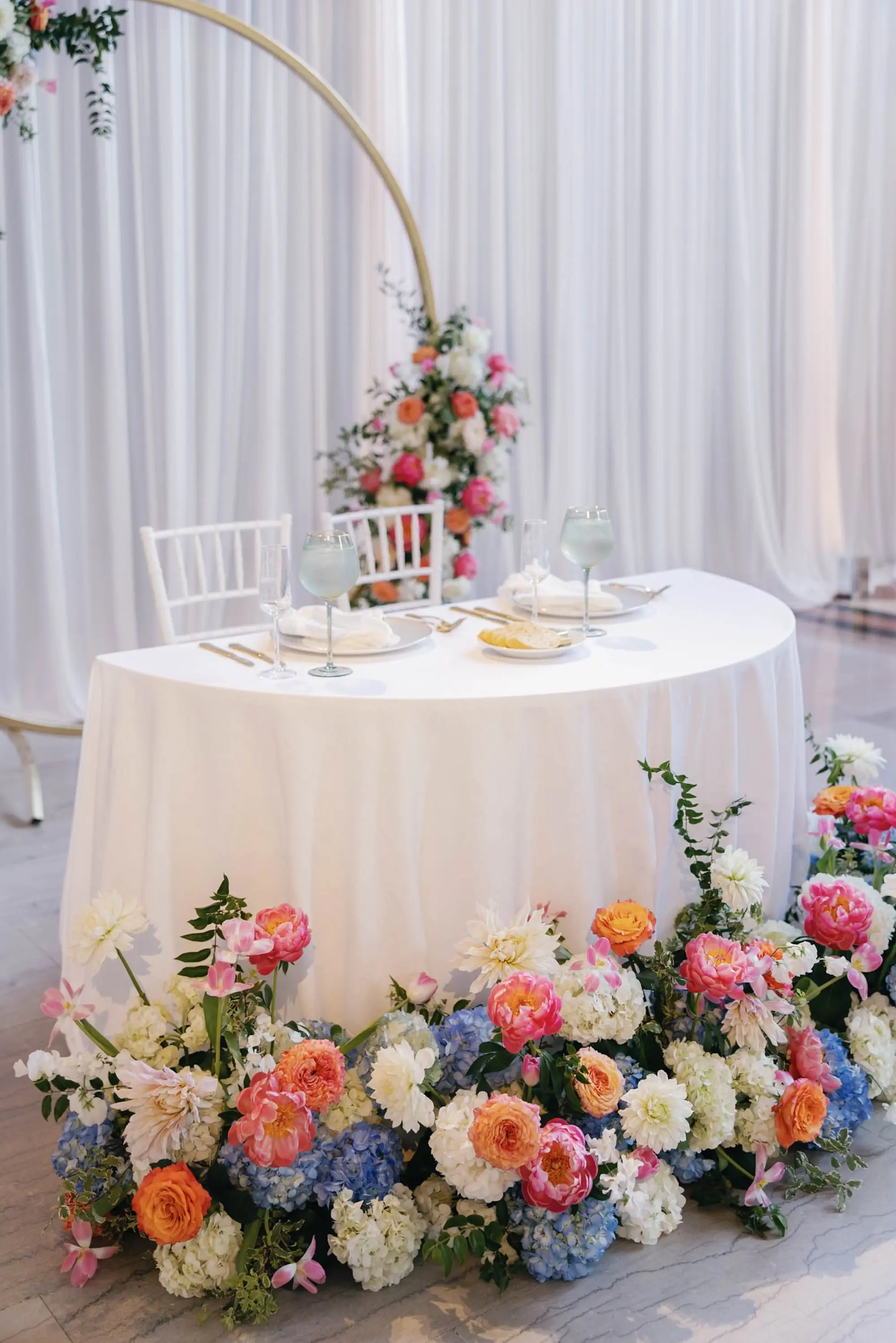 54European Inspired Blue and Green Wedding Inspiration - “Best Of” 2025: Wedding Receptions Part 2 European Inspired Blue and Green Wedding Reception Sweetheart Table Decor Ideas | Pink, Orange, Coral, Peach, White, Light Blue Florals in Greenery Flower Arrangement Decor Ideas | Florist Monarch Events and Design