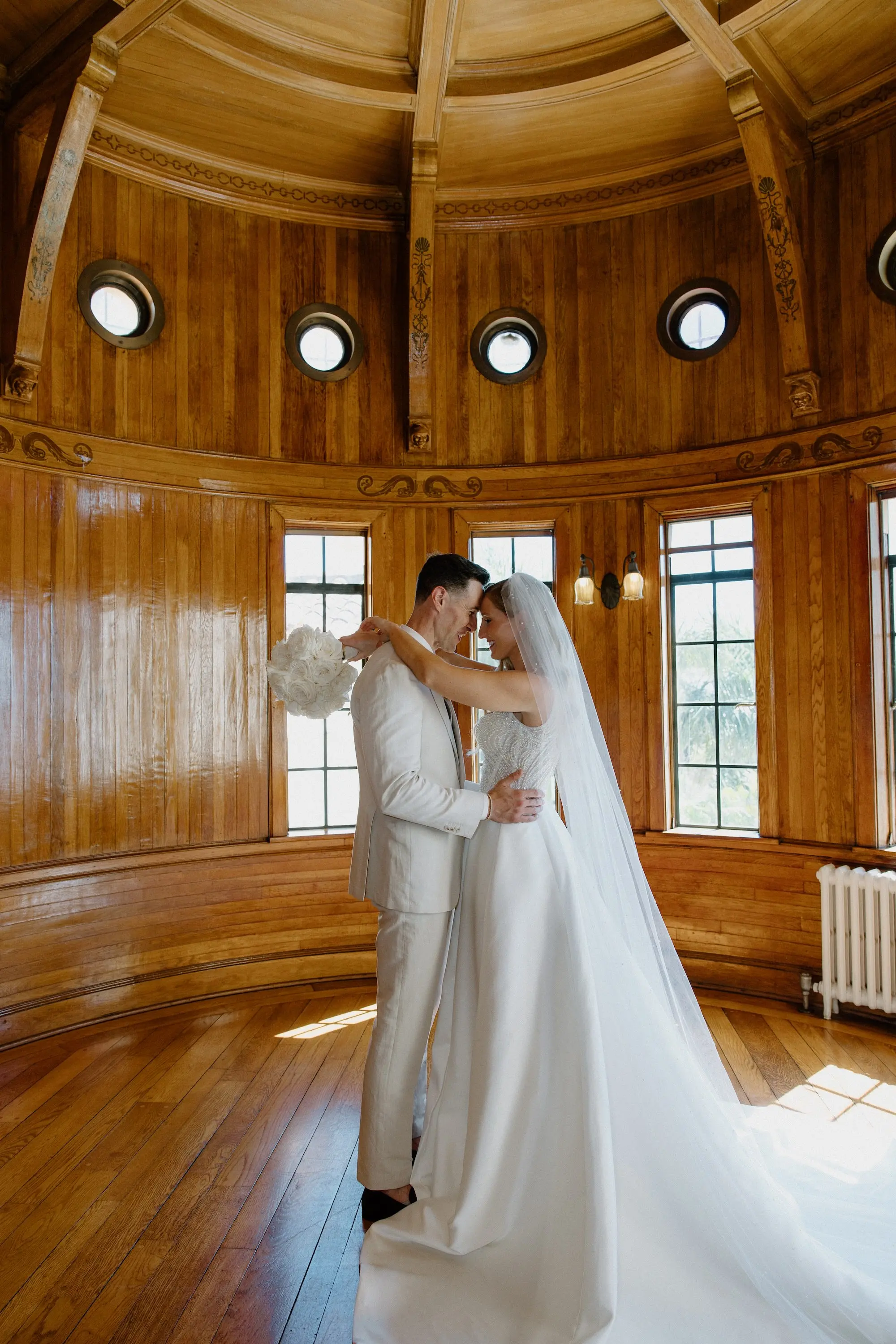 Bride and Groom Classic Wedding Portrait | White Pearl Corset Milla Nova Wedding Gown with Dramatic Satin Train Inspiration | All White Groom Wedding Suit Ideas | Monochromatic White Roses Bridal Bouquet Inspiration | Sarasota Florist Beneva Flowers | Tampa Bay Boutique Truly Forever Bridal | Sarasota Wedding Beachfront Venue Powel Crosely Estate | Content Creator Behind The Vows