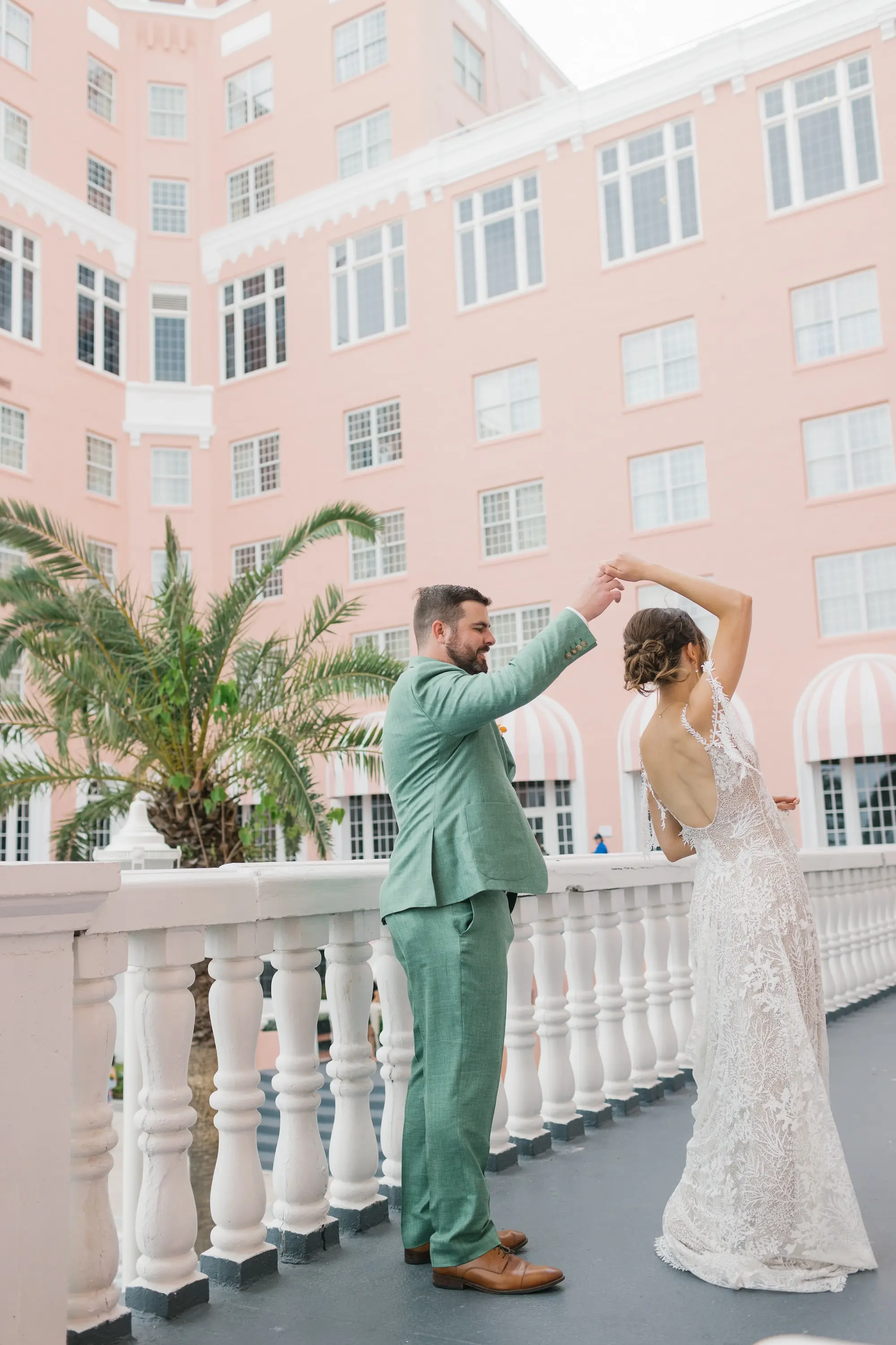 11Tropical Beach Boho Pink and Orange Wedding Inspiration St Pete Venue The Don CeSar - Vibrant, Tropical Boho St. Pete Beach Wedding | The Don CeSar Bride and Groom Balcony Outdoor Wedding Portrait | Historic Pink Palace St Pete Beach Wedding Venue Don CeSar | St Pete Beach Resort Wedding Venue