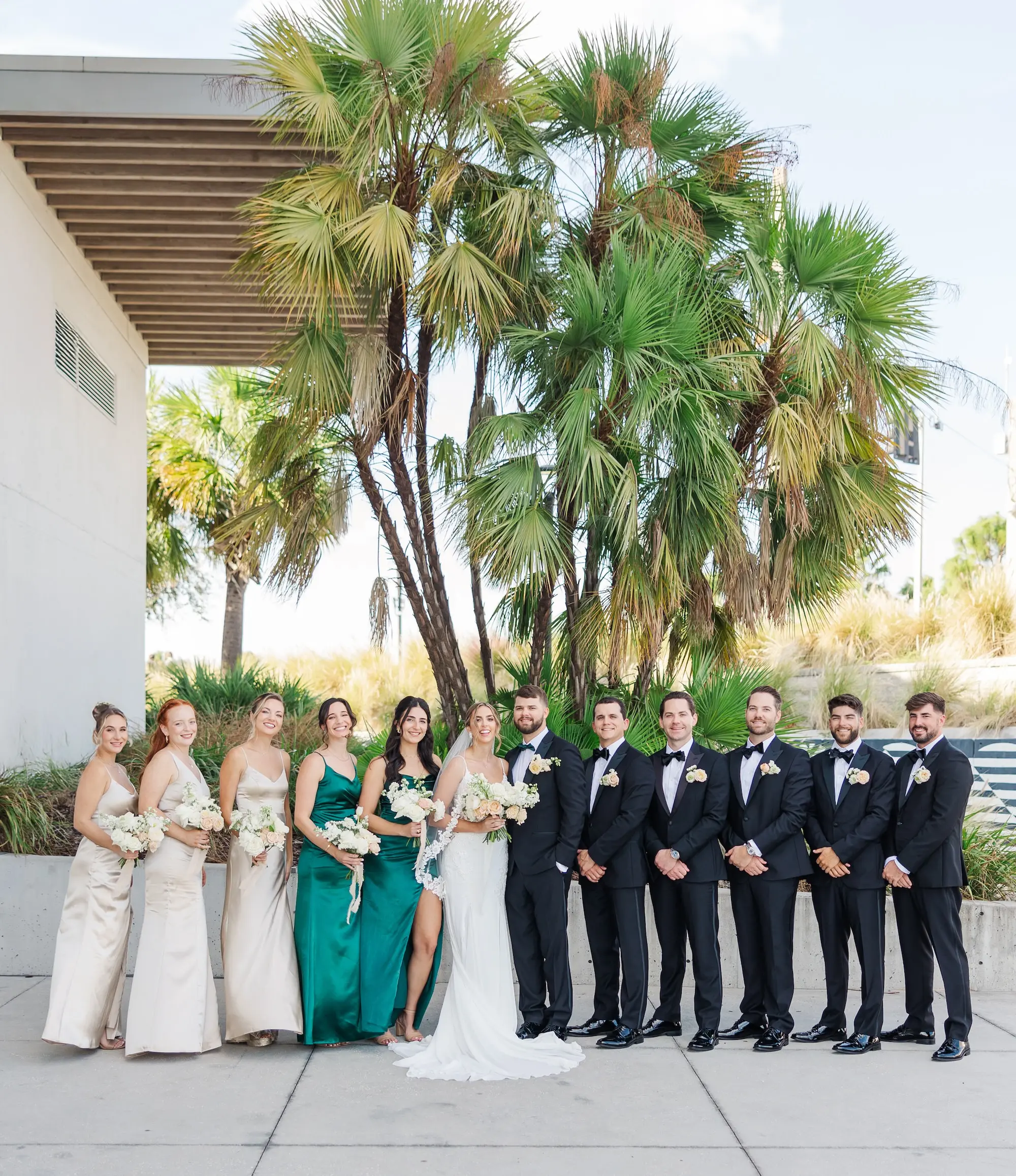 12Classic Emerald Green and Champagne Wedding Inspiration - Classic Emerald Green Downtown Tampa Wedding | Bob Buckhorn Center Bride and Groom with Bridal Party Wedding Portrait | Mismatched Satin Champagne and Emerald Green Bridesmaid Dresses Inspiration | Traditional Black and White Groomsmen Tuxedo Ideas | Tampa Bay Photographer Mary Anna Photography