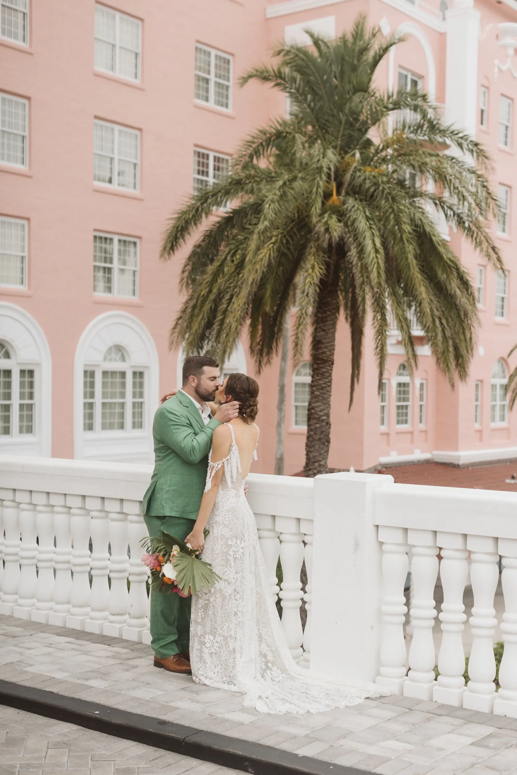 12Tropical Beach Boho Pink and Orange Wedding Inspiration St Pete Venue The Don CeSar - Vibrant, Tropical Boho St. Pete Beach Wedding | The Don CeSar Bride and Groom Kissing Wedding Portrait | Historic Pink Palace St Pete Beach Wedding Venue Don CeSar | St Pete Beach Resort Wedding Venue