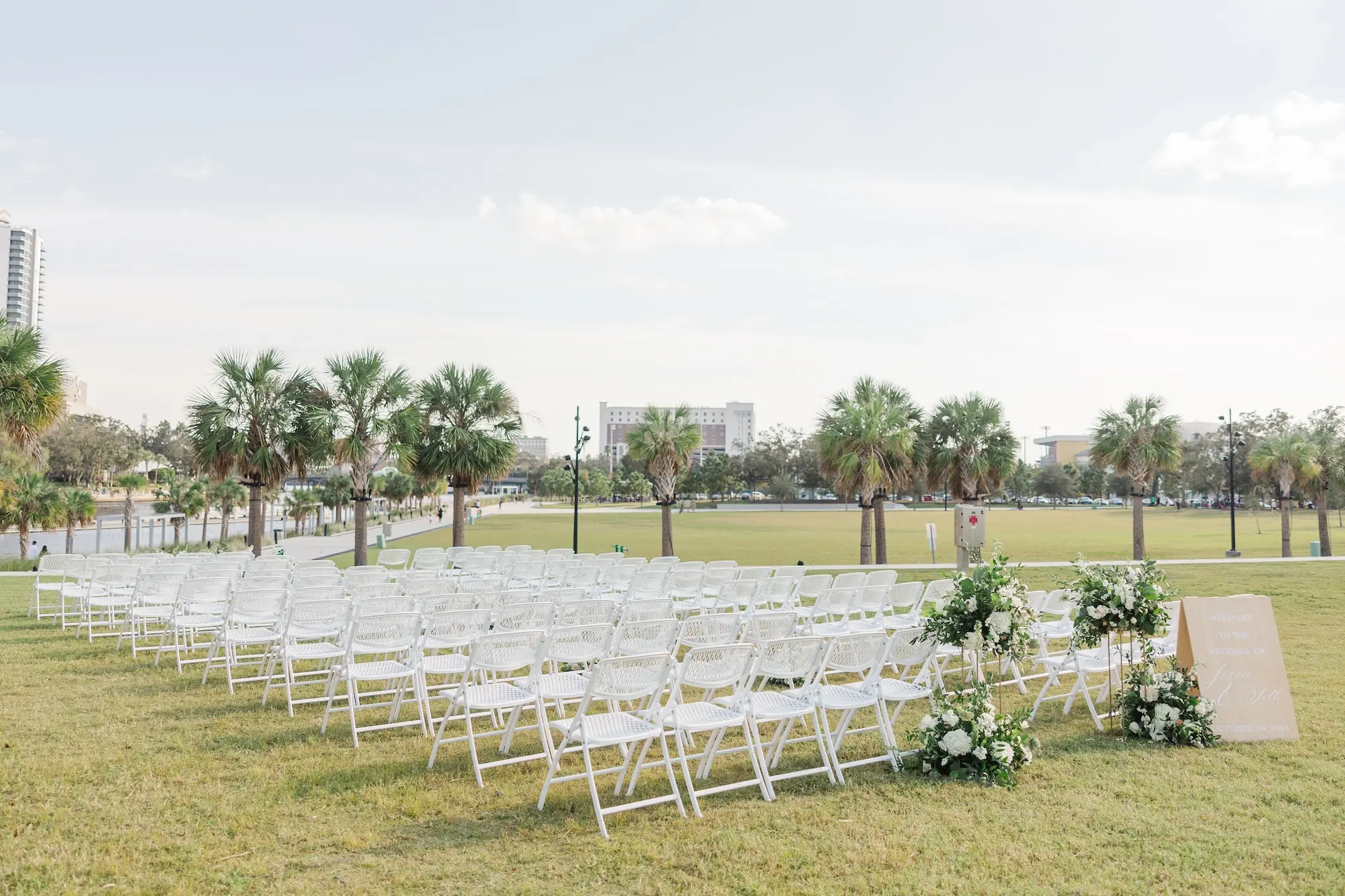 18Classic Emerald Green and Champagne Wedding Inspiration Bob Buckhorn Tampa River Center Venue - Classic Emerald Green Downtown Tampa Wedding | Bob Buckhorn Center White Outdoor Ceremony Chairs Ideas | White Florals with Greenery Arrangements Ceremony Decor Inspiraiton | Venue Tampa River Center