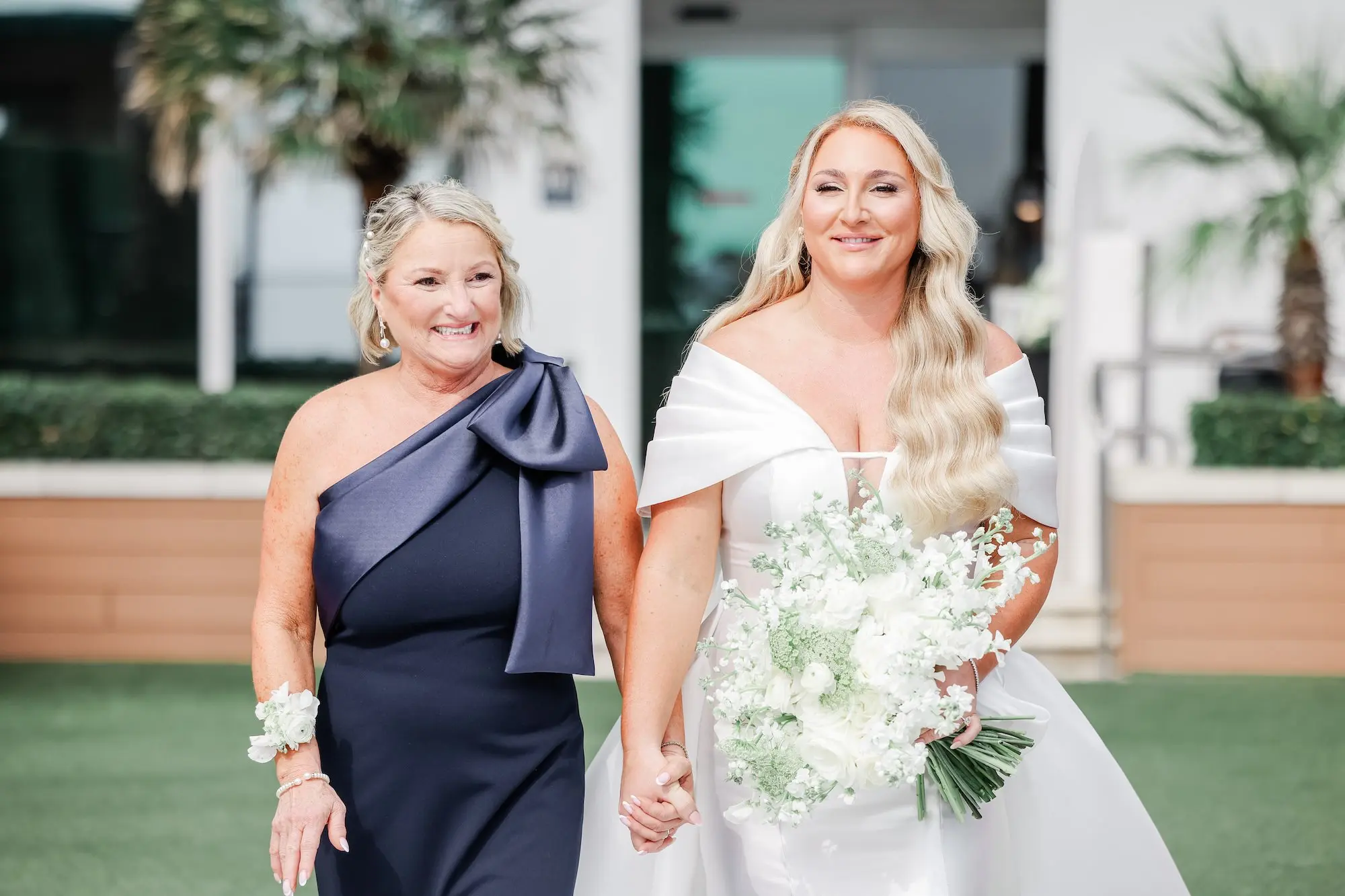 Bride and Mother Walking Down Wedding Aisle