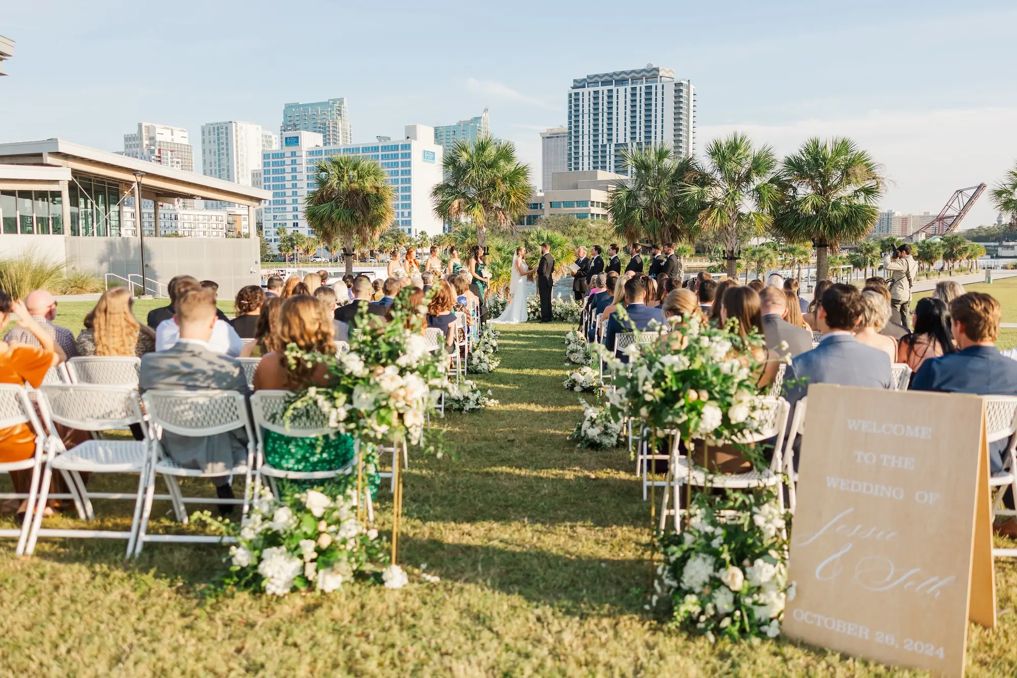 24Classic Emerald Green and Champagne Wedding Inspiration Bob Buckhorn Tampa River Center Venue - Classic Emerald Green Downtown Tampa Wedding | Bob Buckhorn Center Bride and Groom Wedding Ceremony Vow Exchange Wedding Portrait | Outdoor Riverfront Wedding Ceremony Inspiration | White Floral with Greenery Flower Arrangement Aisle Decor Inspiration | Linen Ceremony Sign Ideas | Tampa Bay Planner Wilder Mind Events | Florida Sign Designer madWOLFE | Venue Tampa River Center