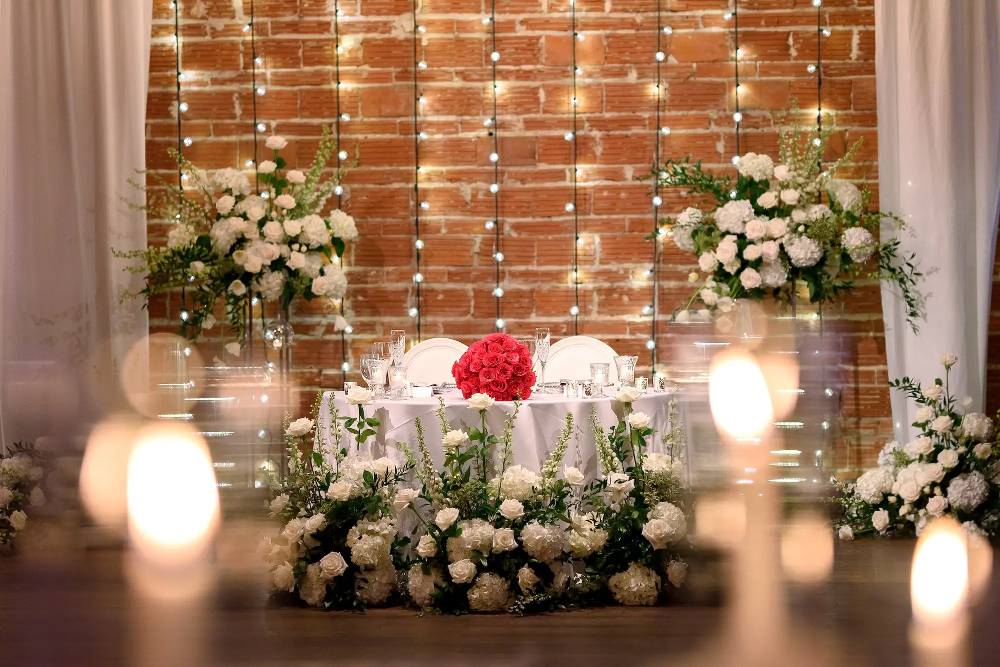 Glamorous White Florals and Greenery Wedding Reception Sweetheart Table Decor Inspiration | String Light Backdrop | St. Petersburg Wedding Venue Nova 535 | Tampa Bay Florist Bruce Wayne Florals