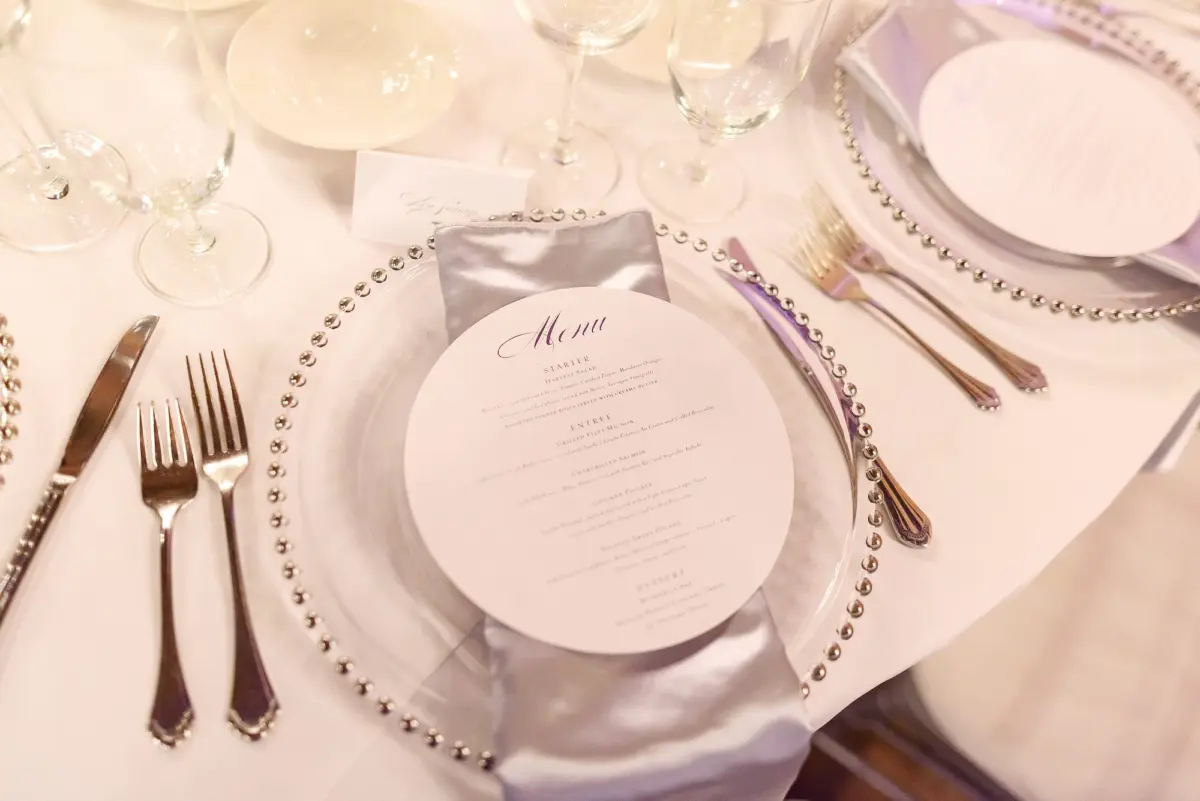 Clear Chargers with Silver Scalloped Edges and Silver Napkins and White Menu Cards Tablescape with Silver Flatware Decor Ideas