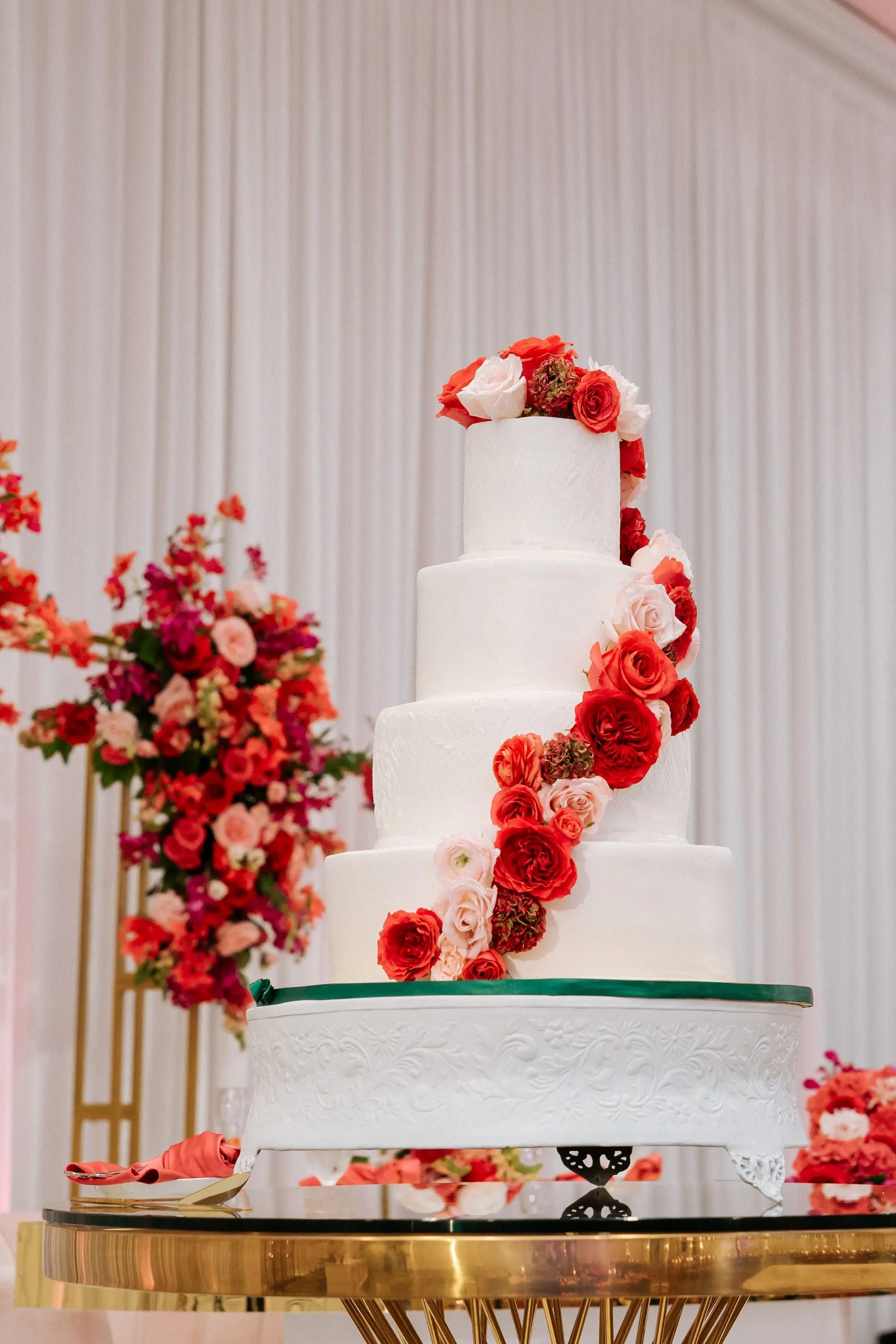 Glamorous Four-Tiered White Wedding Cake with Cascading Pink Flowers | Florist Save The Date Florida