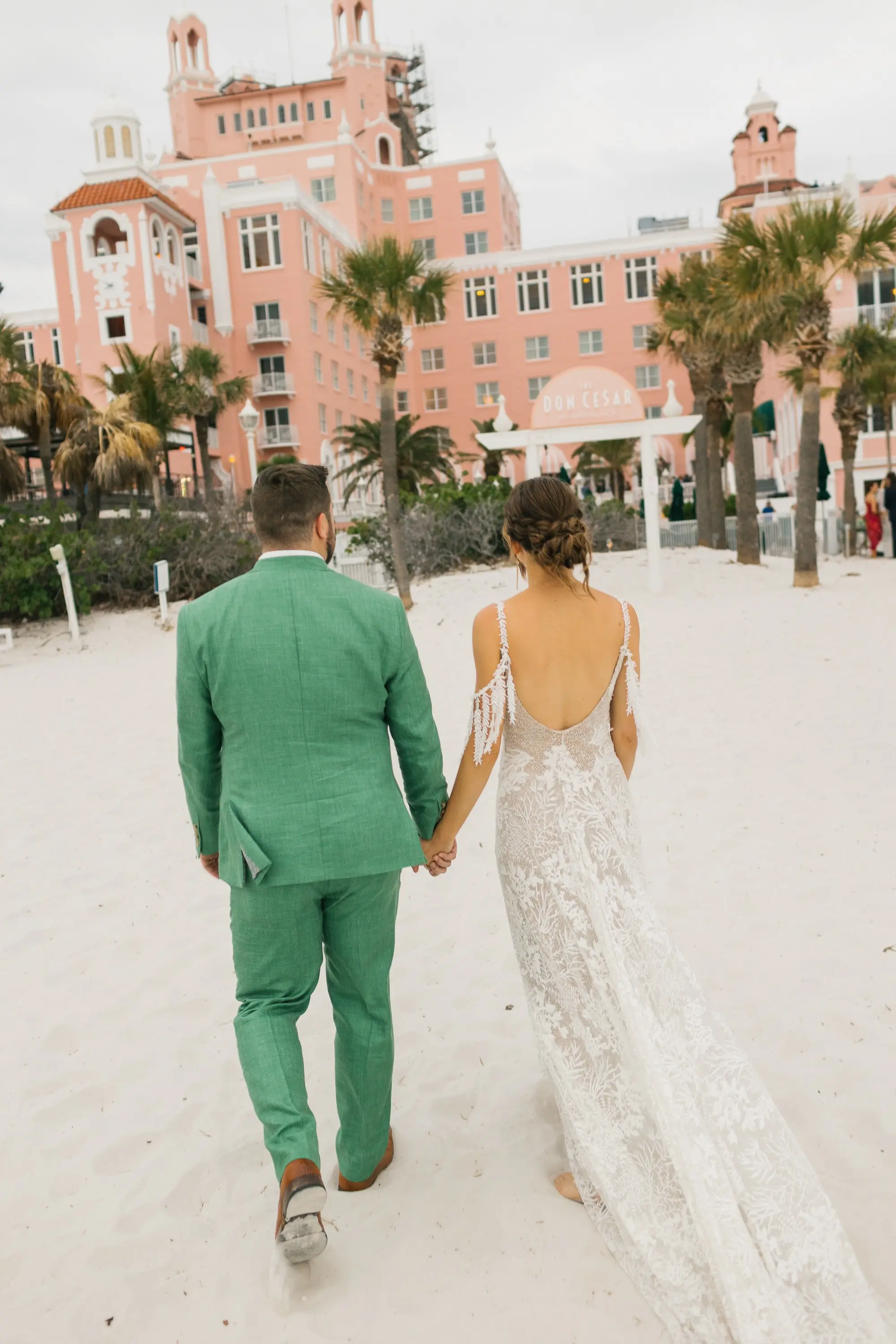 30Tropical Beach Boho Pink and Orange Wedding Inspiration St Pete Venue The Don CeSar - Vibrant, Tropical Boho St. Pete Beach Wedding | The Don CeSar Bride and Groom Beach Wedding Portrait | Braided Low Bun Boho Wedding Hairstyle Inspiration | Effortlessly Romantic Bohemian Grace Loves Lace Wedding Gown with Scooped Back, Detailed Floral Lace and Off-the-Shoulder Tasseled Armbands Ideas | Tampa Bay Hair and Makeup Artist Femme Akoi Beauty Studio | Historic Pink Palace St Pete Beach Wedding Venue Don CeSar | St Pete Beach Resort Wedding Venue