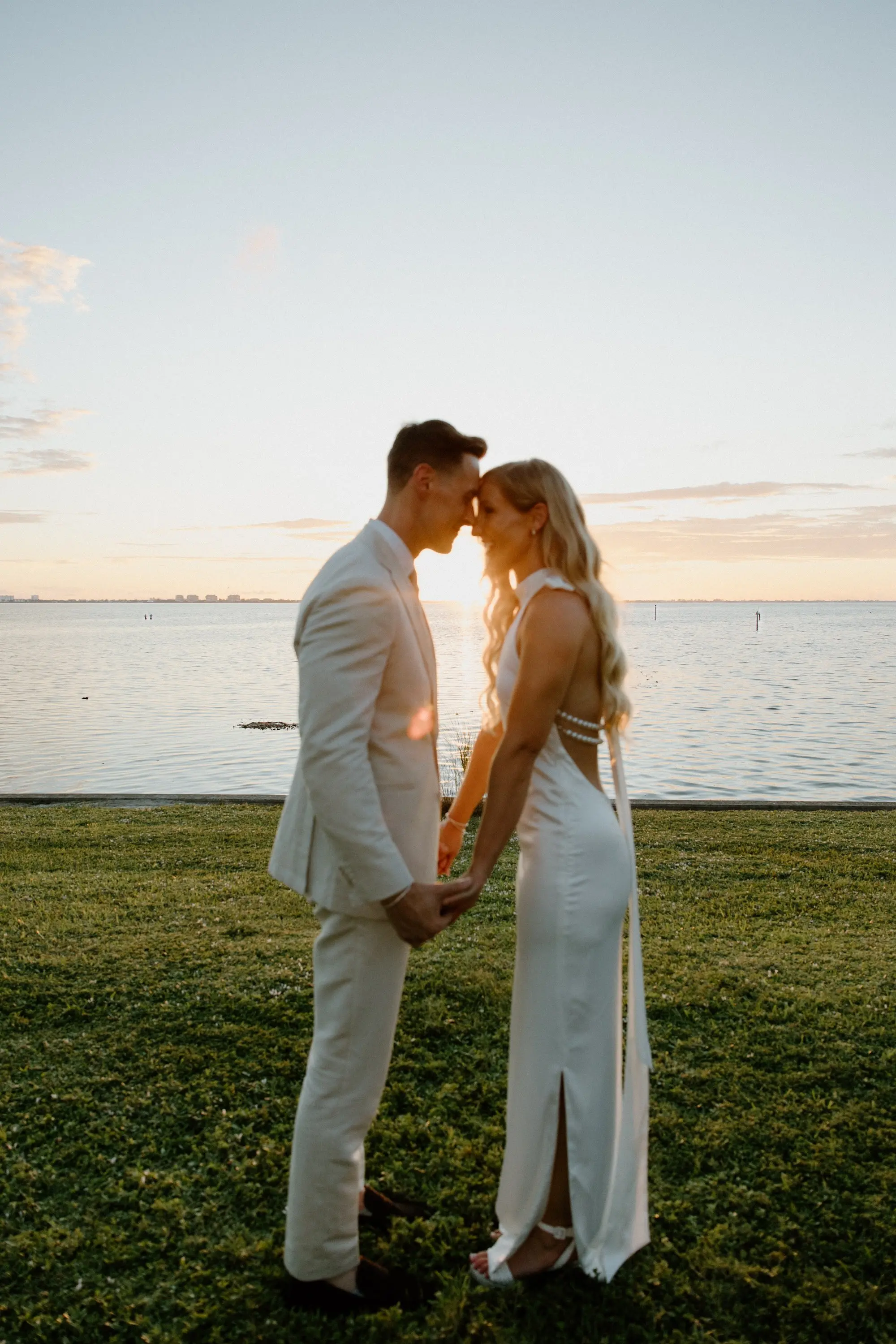 Bride and Groom Oceanfront Golden Hour Wedding Portrait | Hollywood Glam Curled Waves Wedding Bridal Hair Inspiration | Sarasota Hair and Makeup Artist Femme Akoi Beauty Studio