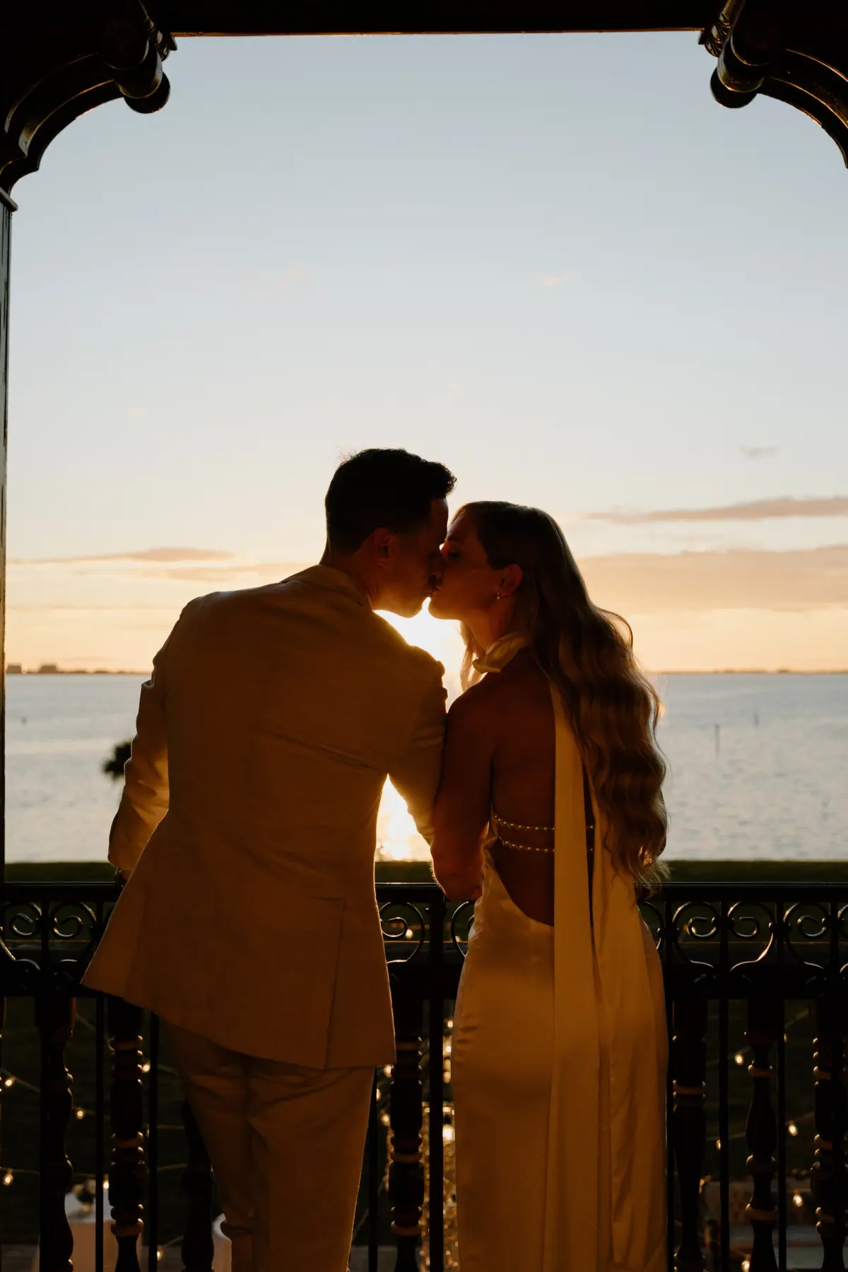 Bride and Groom Golden Hour Oceanview Wedding Portrait | Hollywood Glam Curled Waves Wedding Bridal Hair Inspiration | Sarasota Hair and Makeup Artist Femme Akoi Beauty Studio