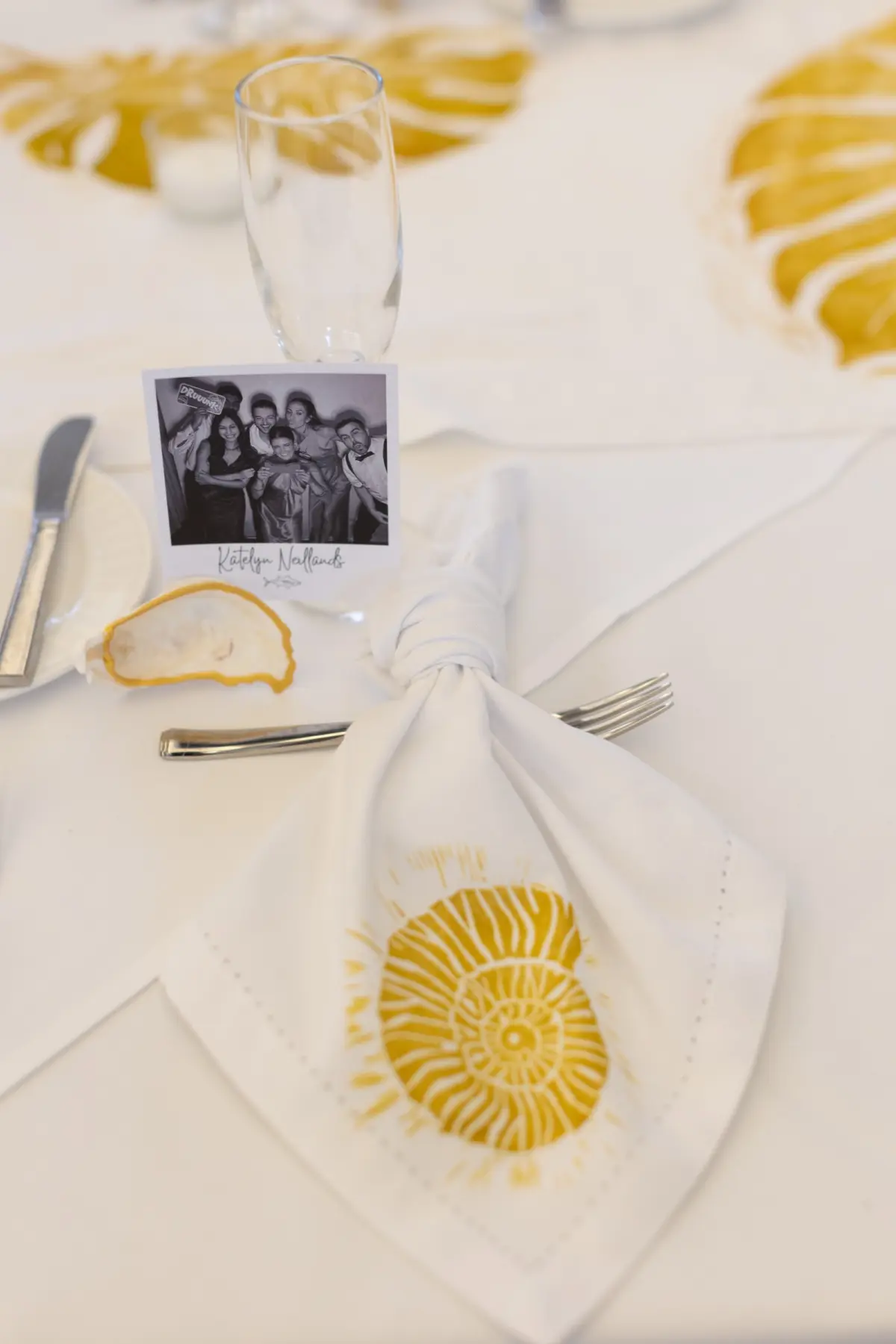 38Tropical Beach Boho Pink and Orange Wedding Inspiration - Vibrant, Tropical Boho St. Pete Beach Wedding | The Don CeSar Boho Beach White Linen Napkins Embroidered with Gold Seashells Wedding Reception Tablescape Decor Inspiration | Oyster Shells Decor Ideas | Polaroid Name Plates Inspiration