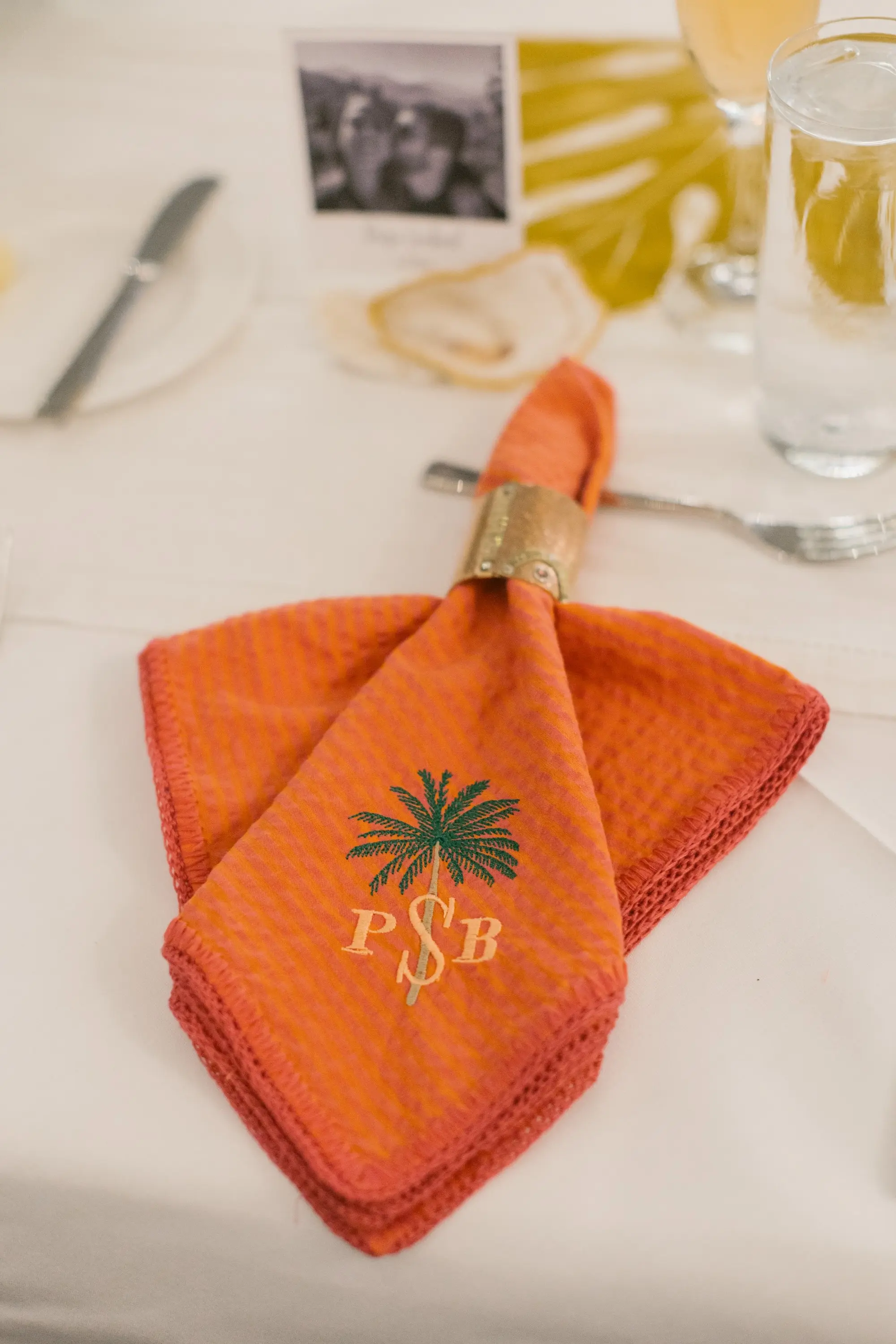 39Tropical Beach Boho Pink and Orange Wedding Inspiration - Vibrant, Tropical Boho St. Pete Beach Wedding | The Don CeSar Boho Beach Palm Tree Personalized Burnt Orange Linen Napkins with Gold Napkin Holder Wedding Reception Table Decor Inspiration