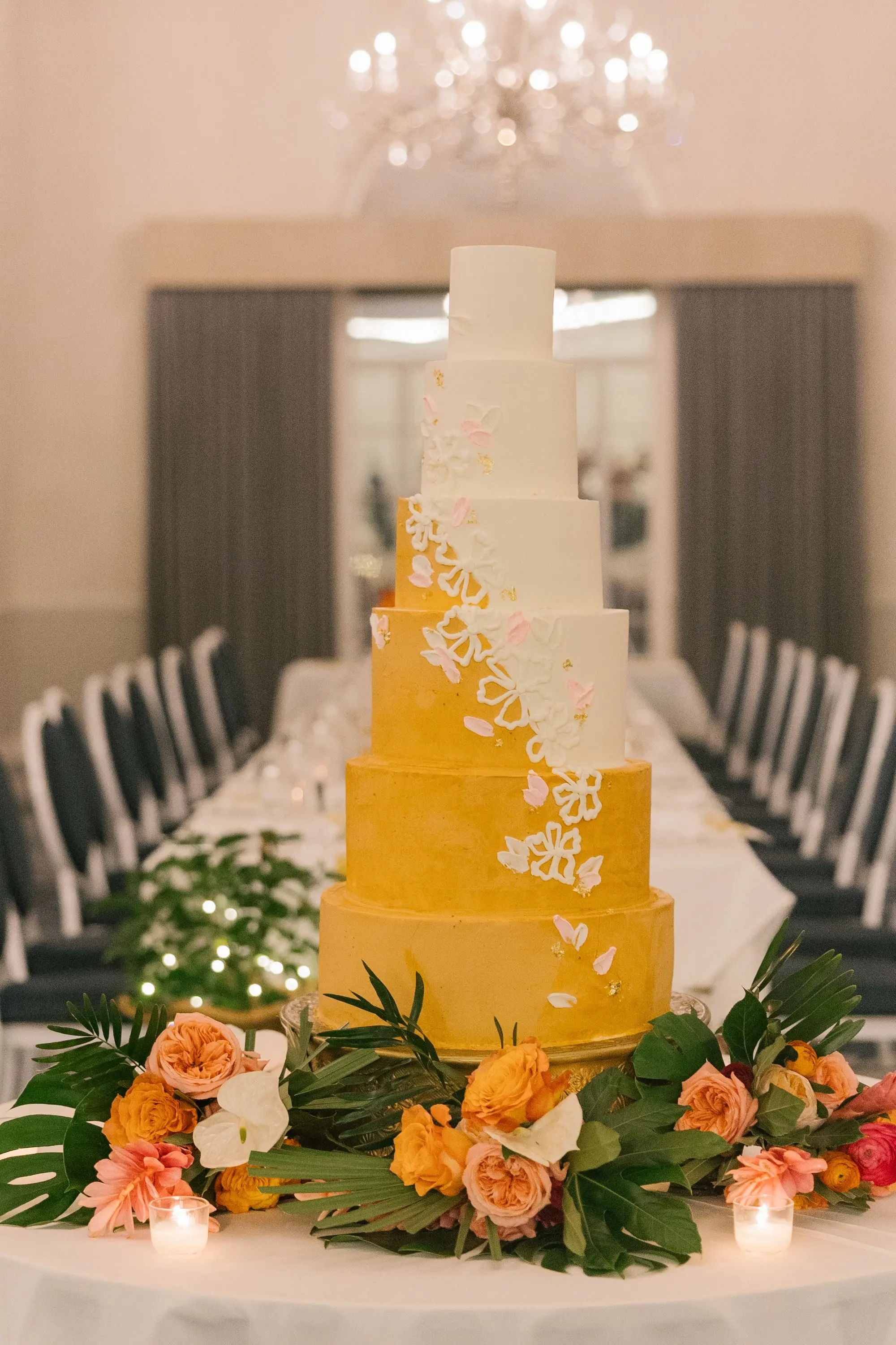 43Tropical Beach Boho Pink and Orange Wedding Inspiration - Vibrant, Tropical Boho St. Pete Beach Wedding | The Don CeSar White and Gold Six Tier Wedding Cake with White Floral Detail Inspiration | Peach, Pink, Orange, White Florals with Green Palm Fronds Wedding Reception Decor Ideas