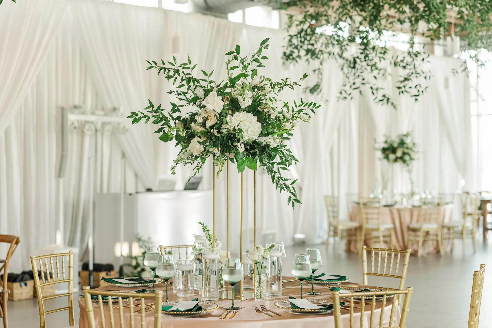 44Classic Emerald Green and Champagne Wedding Inspiration - Classic Emerald Green Downtown Tampa Wedding | Bob Buckhorn Center Elegant Riverfront Ballroom Wedding Reception | Gold Chiavari Chairs | Tall Gold Platform Centerpieces with White Hydrangeas, Roses, Wisteria Flower and Palm Greenery Arrangement Ideas | Clear Chargers with Gold Scalloped Edges and Emerald Green Napkins Tablescape Decor Inspiration | Tampa Bay Planner Wilder Mind Events | Florida Elite Events Catering | Venue Tampa River Center