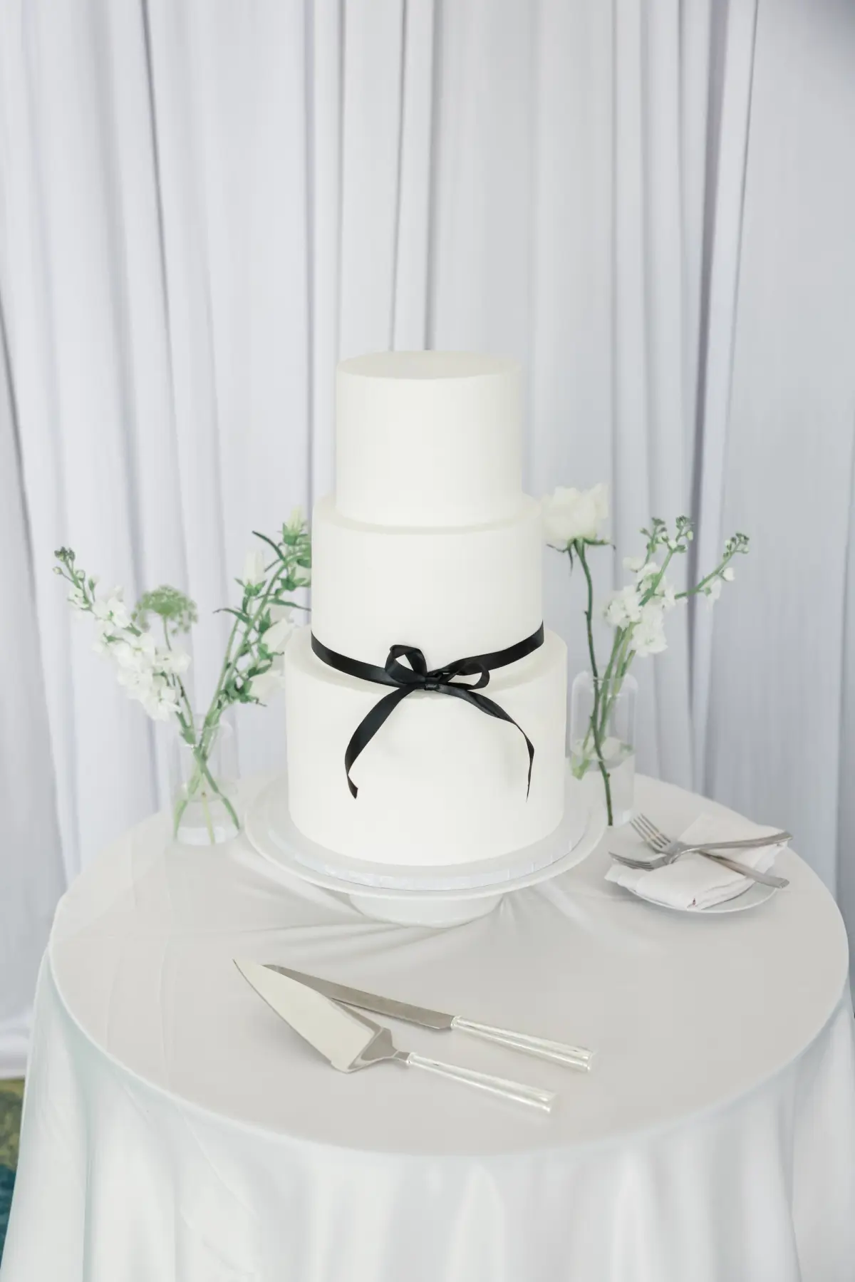 White Round Three-Tiered Wedding Cake with Black Ribbon Bow Inspiration
