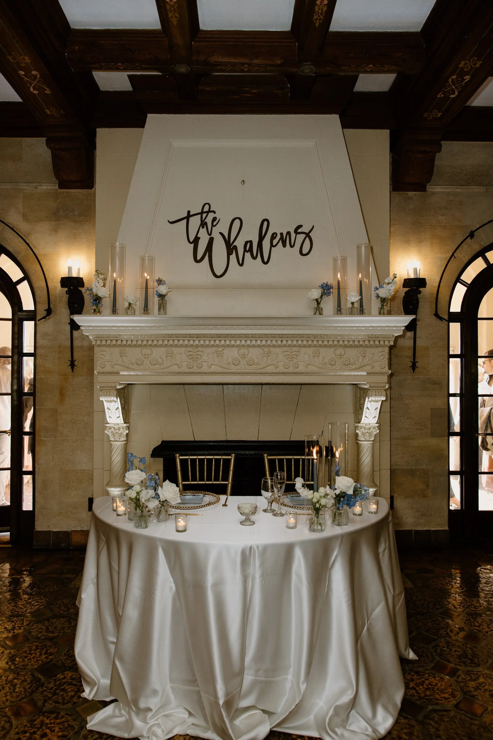 Timeless White Satin Table Linen Sweetheart Table Wedding Reception Decor Inspiration | Black Cursive Last Name Decor Ideas | White Roses and Blue Florals Bud Vases Arrangement Decor Inspiration