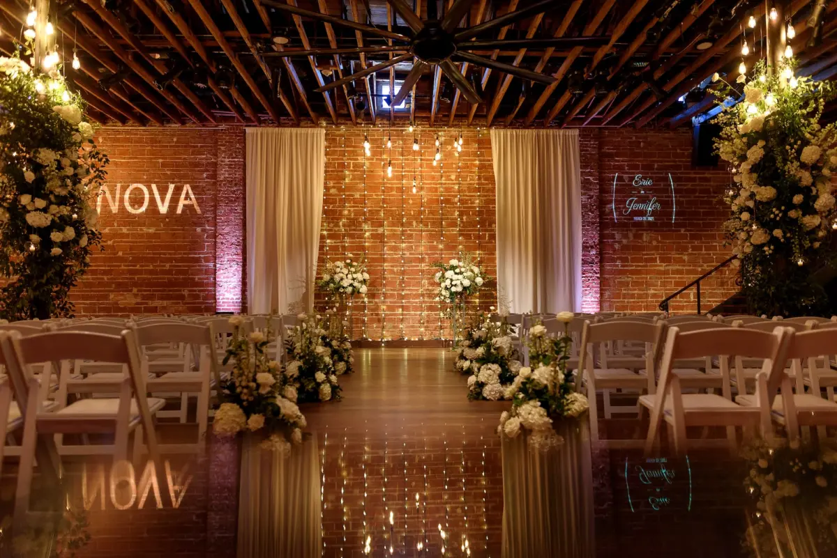 Glamorous White Florals and Greenery Wedding Ceremony Decor Inspiration | Exposed Industrial Brick Wedding Ceremony Venue Ideas | White Ceremony Chairs Inspiration | St. Petersburg Wedding Venue Nova 535 | Tampa Bay Florist Bruce Wayne Florals