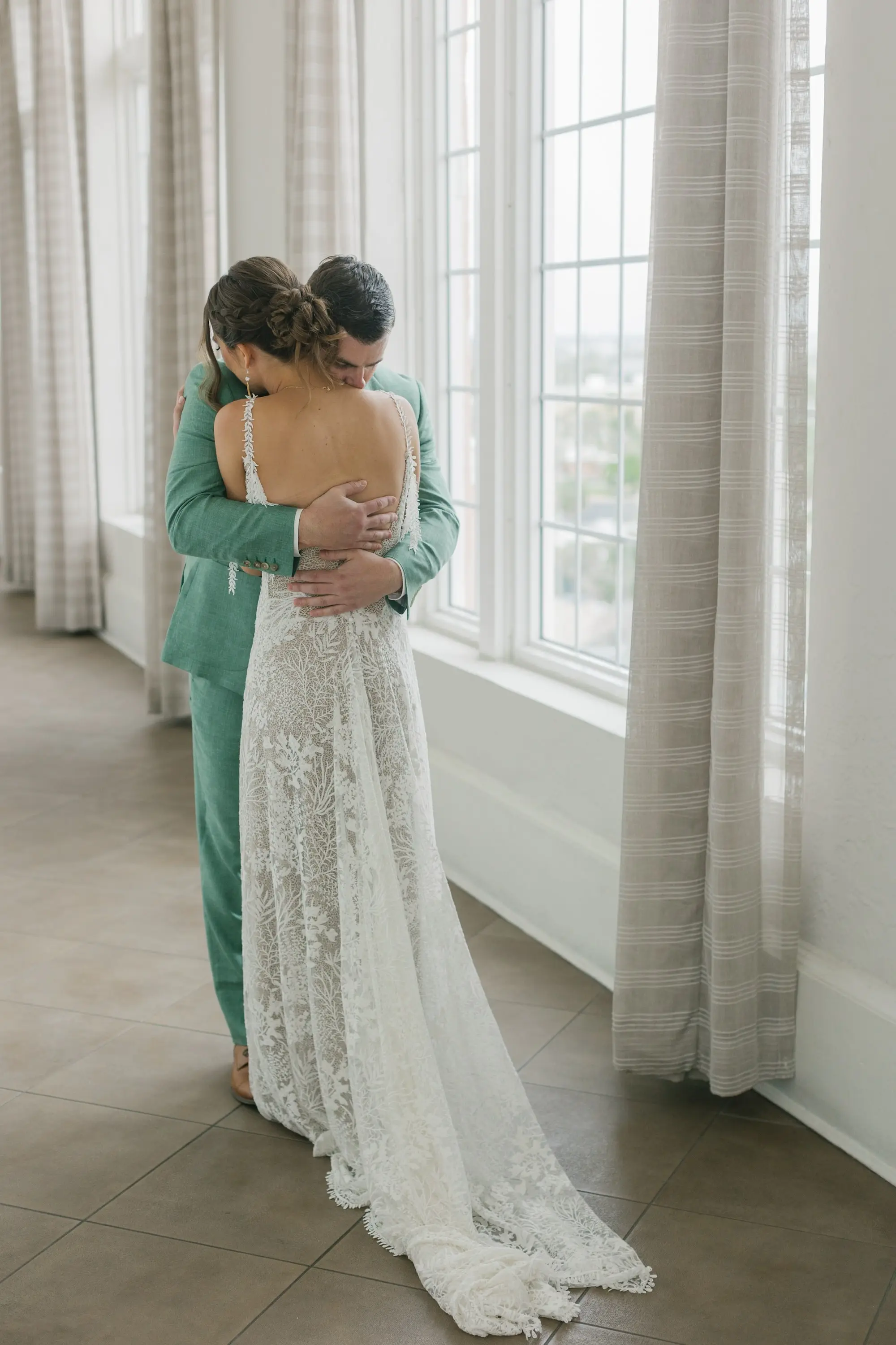 4Tropical Beach Boho Pink and Orange Wedding Inspiration - Vibrant, Tropical Boho St. Pete Beach Wedding | The Don CeSar Bride and Groom First Look Wedding Portrait | Groom's Sage Green Linen Wedding Suit Attire Ideas | Boho Braided Low Bun Wedding Hairstyle Inspiration | Romantic Bohemian Grace Loves Lace Wedding Gown with Detailed Floral Lace and Off-the-Shoulder Tasseled Armbands Ideas | Tampa Bay Hair and Makeup Artist Femme Akoi Beauty Studio