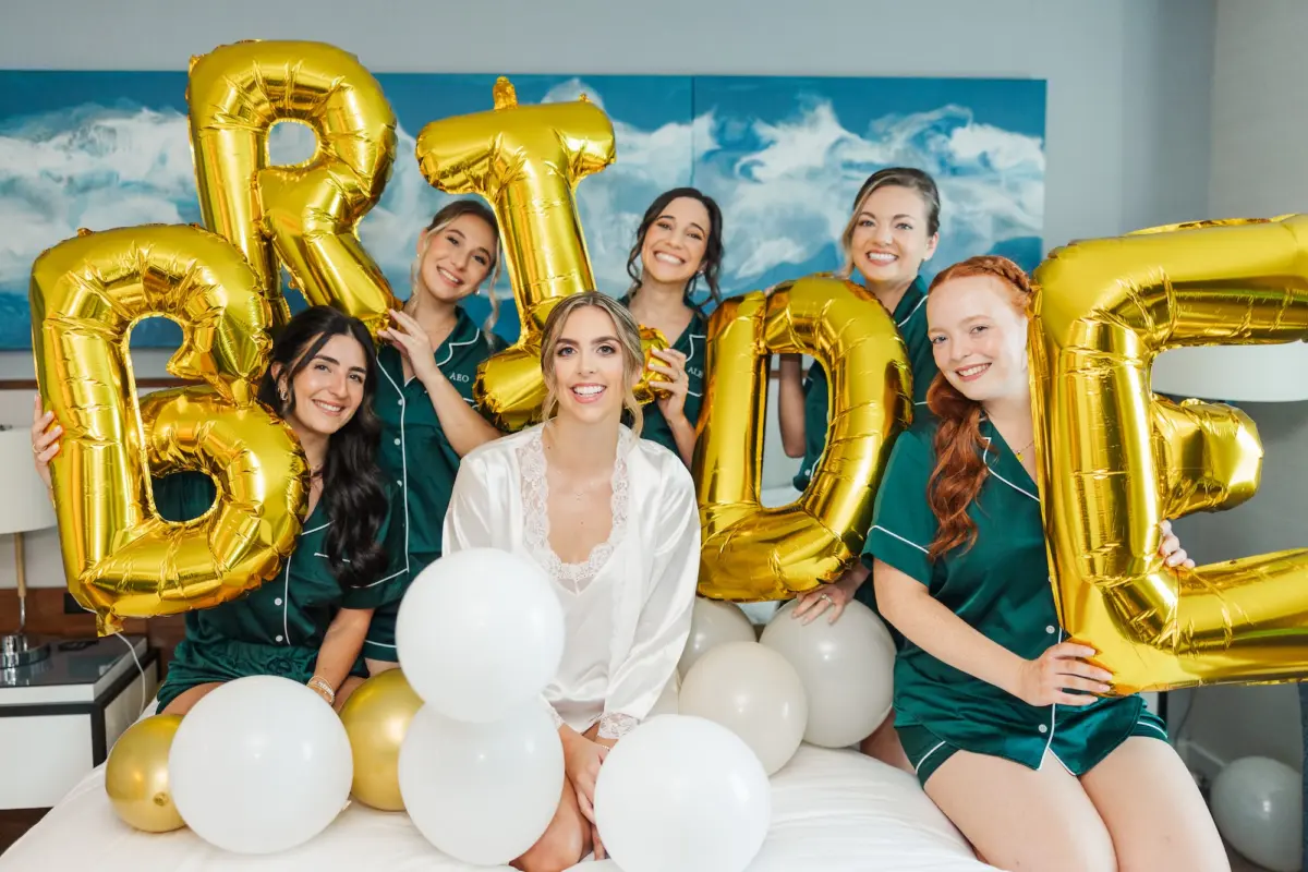5Classic Emerald Green and Champagne Wedding Inspiration - Classic Emerald Green Downtown Tampa Wedding | Bob Buckhorn Center Bride and Bridesmaids Getting Ready Wedding Portrait in Matching Emerald Green Satin PJ Sets | Gold Helium Bride Balloons Ideas
