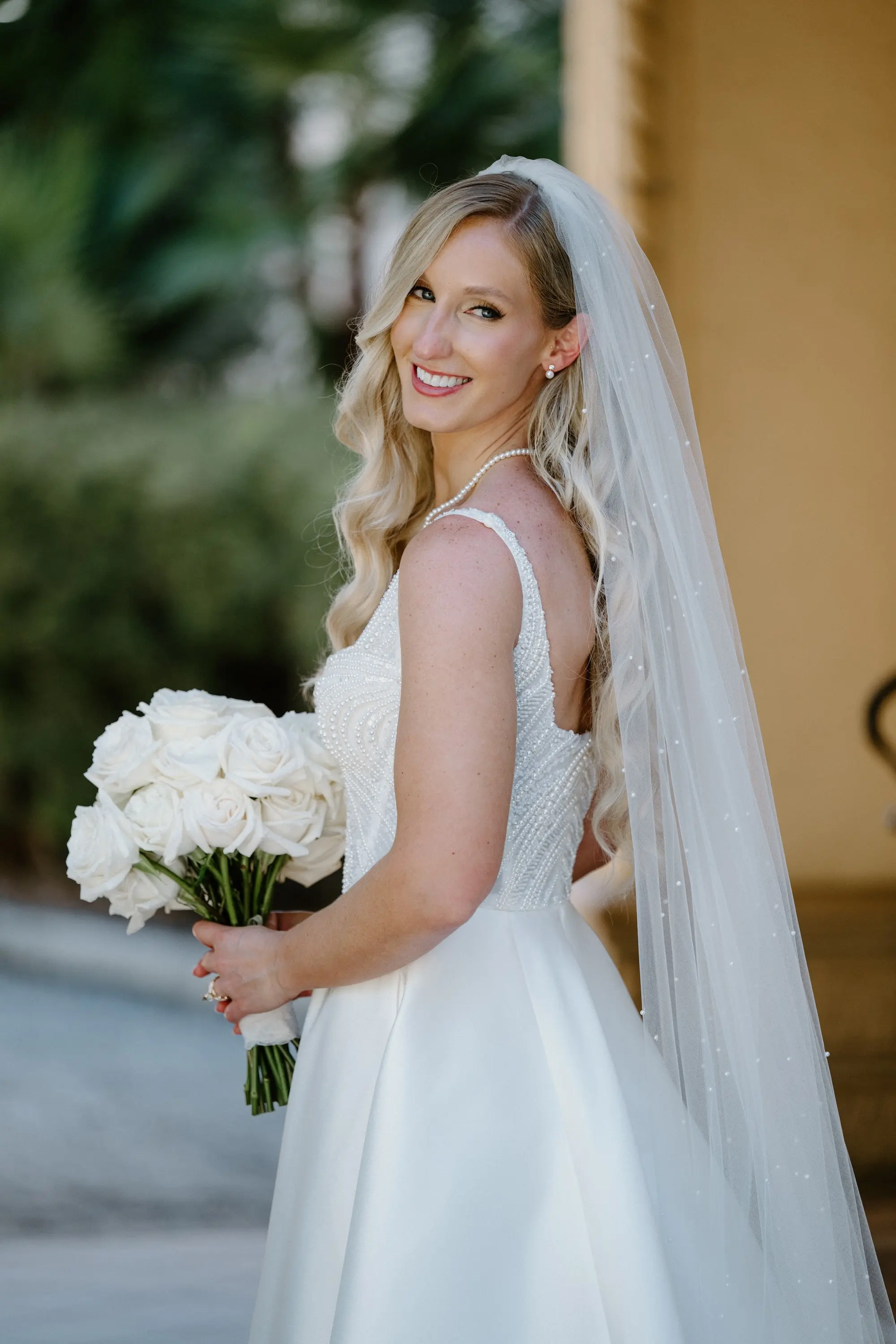 Bride Wedding Portrait | White Pearl Corset Milla Nova Wedding Gown with Satin Skirt Inspiration | Monochromatic White Roses Bridal Bouquet Ideas | Hollywood Glam Curled Waves Wedding Bridal Hair Inspiration | Natural Glam Makeup Ideas | Sarasota Florist Beneva Flowers | Tampa Bay Boutique Truly Forever Bridal | Sarasota Hair and Makeup Artist Femme Akoi Beauty Studio | Content Creator Behind The Vows