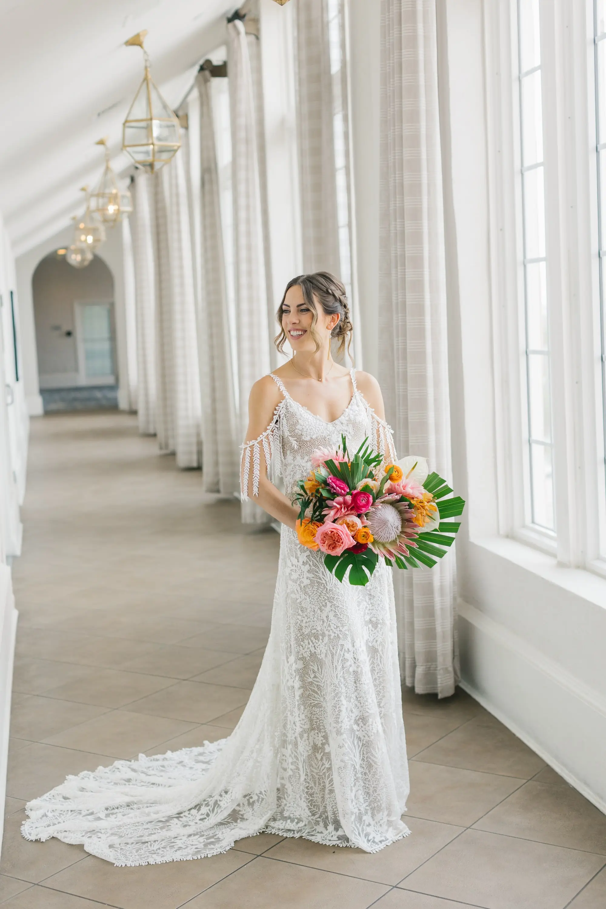 7Tropical Beach Boho Pink and Orange Wedding Inspiration - Vibrant, Tropical Boho St. Pete Beach Wedding | The Don CeSar Bride Wedding Portrait | Low Bun with Loose Curls Boho Wedding Hairstyle Inspiration | Natural Beauty Wedding Makeup Ideas | Romantic Bohemian Grace Loves Lace Wedding Gown with Detailed Floral Lace and Off-the-Shoulder Tasseled Armbands Inspiration | Boho Tropical Pink, Orange, Red, White with Large Palm Fronds Floral Bouquet Ideas | Tampa Bay Hair and Makeup Artist Femme Akoi Beauty Studio