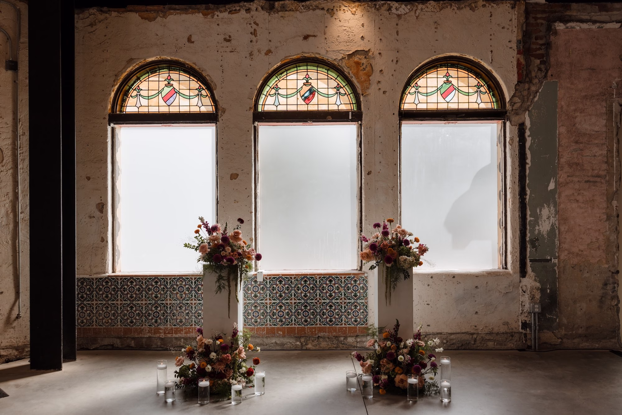Historic Wedding Ceremony with Arched Stained Glass Windows Ideas | Fall Color Florals of Deep Red, Orange, Blush and Purple Wedding Ceremony Altar Decor Inspiration | Las Novedades Wedding Ceremony Ybor City Venue at Hotel Haya