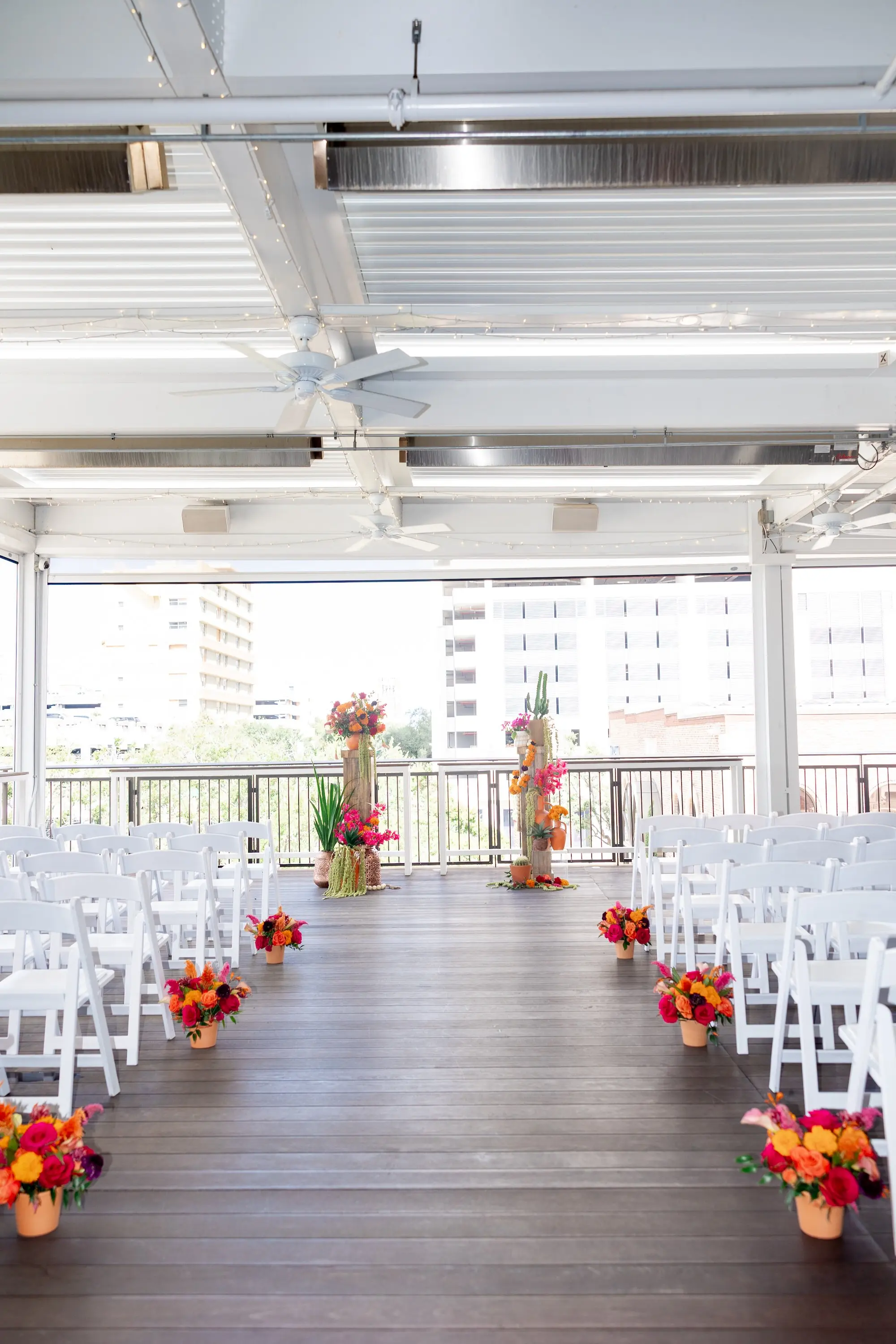 13Vibrant Southwestern Terracotta Pink and Orange Wedding Ideas St Pete Venue Red Mesa Events - Vibrant, Rooftop Wedding Inspiration Shoot | Red Mesa Events Downtown St Pete Vibrant Southwestern Mexican Inspired Balcony Wedding Ceremony Inspiration | White Ceremony Chairs | Bright Pink, Yellow, Red, Orange Floral Arrangements in Terracotta Pots Aisle Decor Ideas | Tampa Bay Florist Save The Date Florida | St Pete Event Planner Coastal Coordinating | Downtown St Pete Event Venue Red Mesa Events