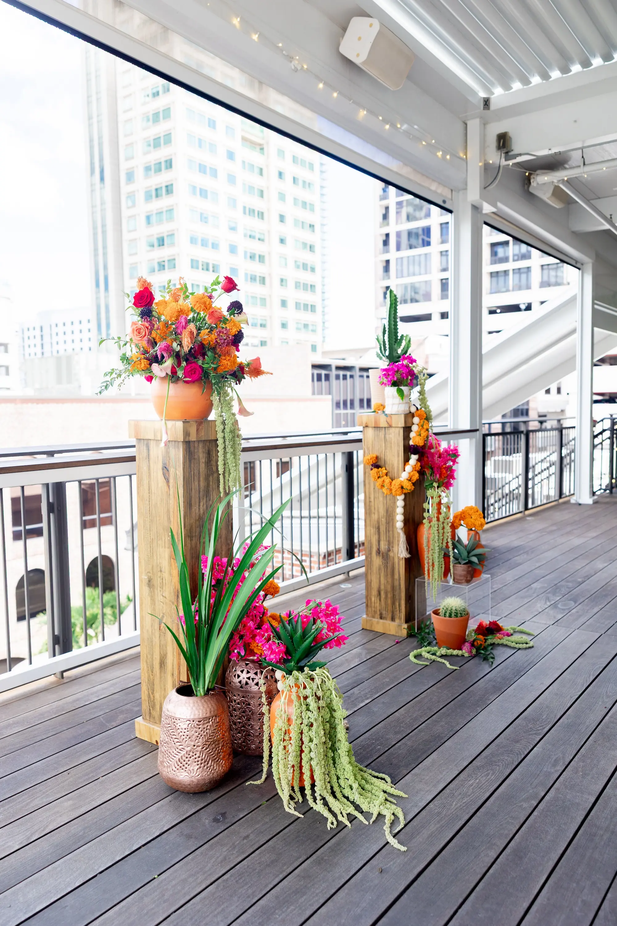 14Vibrant Southwestern Terracotta Pink and Orange Wedding Ideas - Vibrant, Rooftop Wedding Inspiration Shoot | Red Mesa Events Vibrant Southwest Mexican Wedding Reception Ideas | Bright Pink and Orange Floral Arrangements on Rustic Wooden Columns with Lush Green Succulents and Cacti Greenery Arrangement Reception Decoration Inspiration | Terracotta Pots Decor Ideas | Tampa Bay Florist Save The Date Florida | St Pete Event Planner Coastal Coordinating