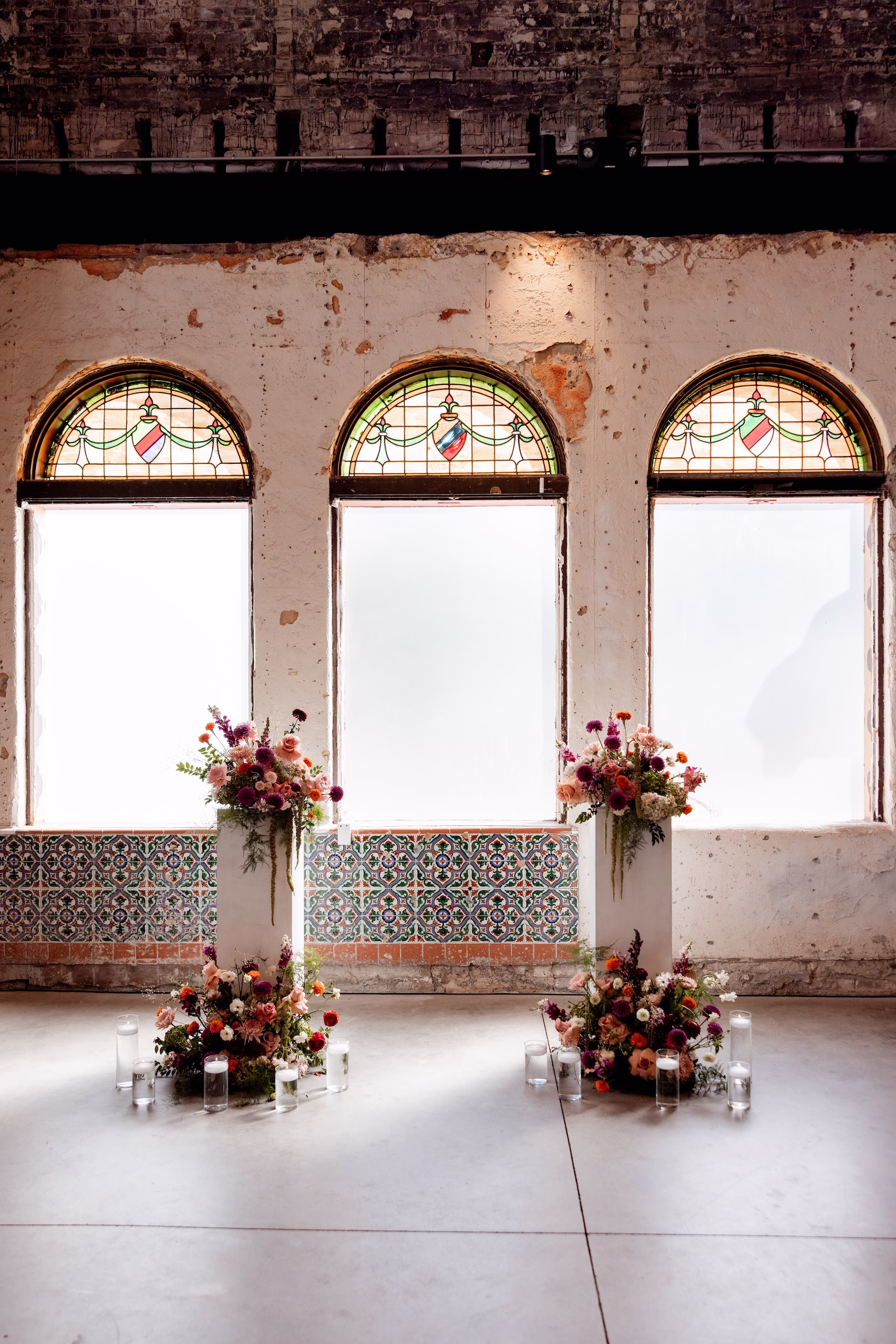 Historic Wedding Ceremony with Arched Stained Glass Windows Ideas | Fall Color Florals of Deep Red, Orange, Blush and Purple Wedding Ceremony Altar Decor Inspiration | Las Novedades Wedding Ceremony Ybor City Venue at Hotel Haya