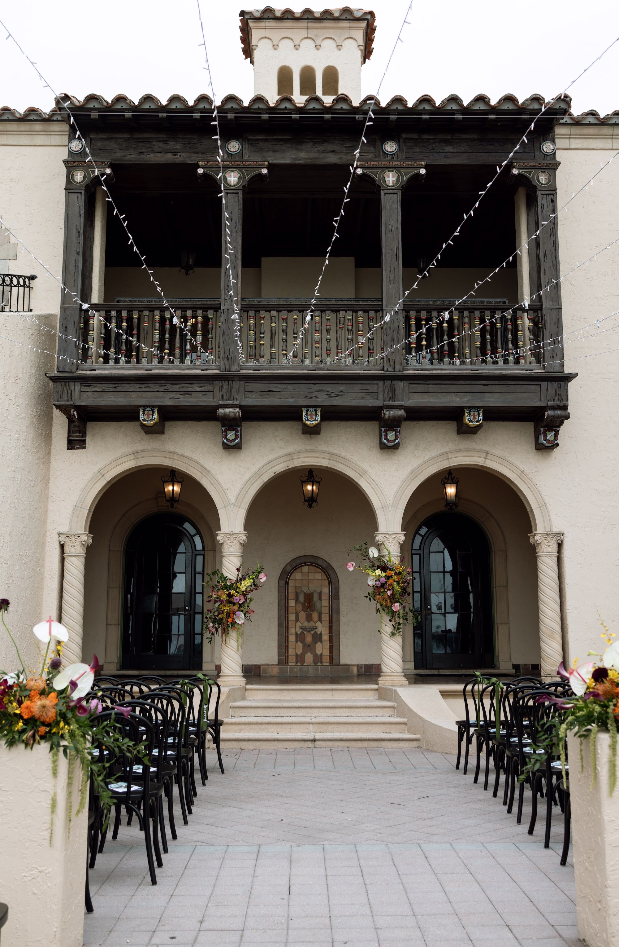 Outdoor Fall Florida Wedding Ceremony Inspiration | Overhead Bistro Lights Decor Ideas | Black Wedding Ceremony Chairs Inspiration | Sarasota Event Venue Powel Crosley Estate