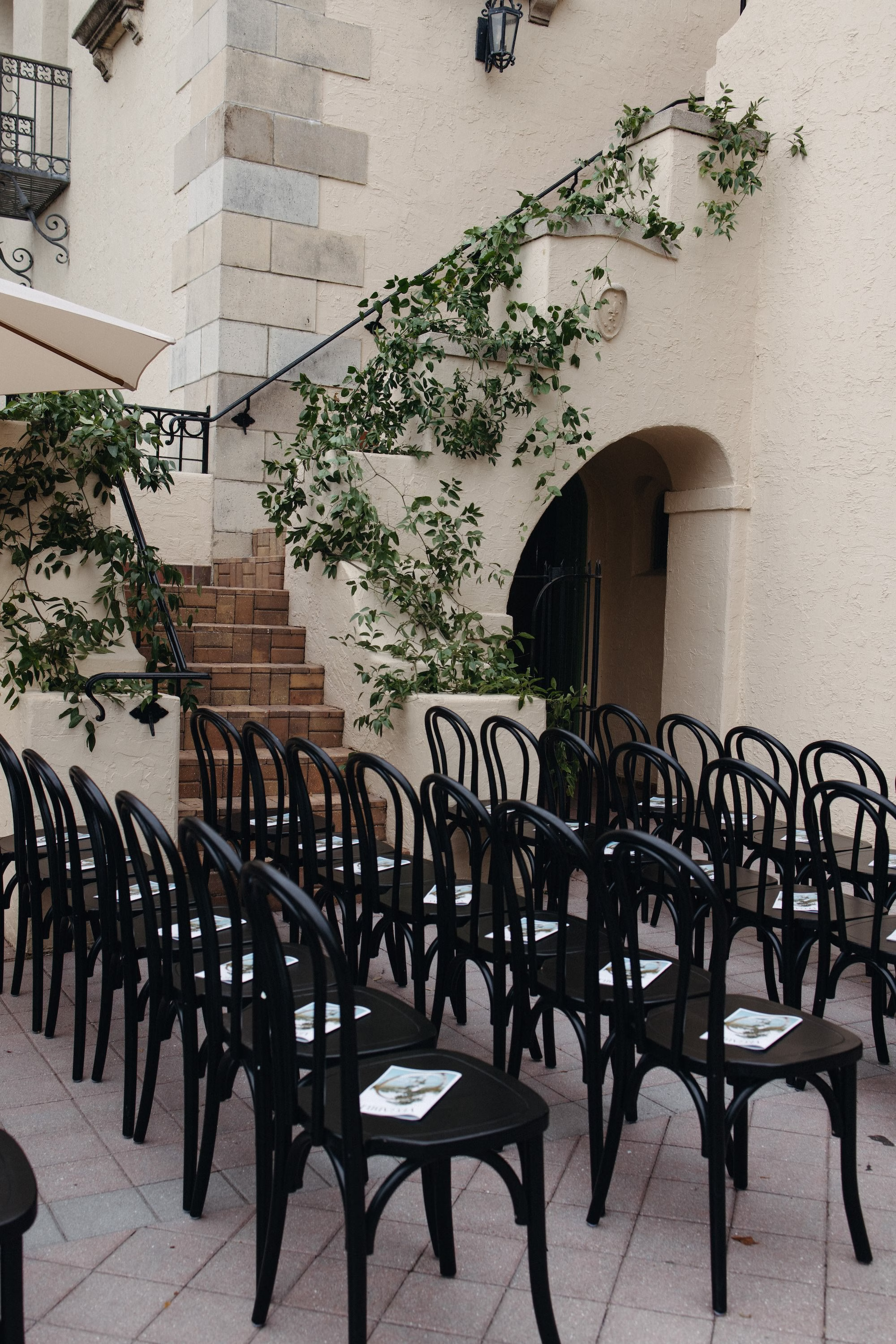 Outdoor Fall Florida Wedding Ceremony Inspiration | Overhead Bistro Lights Decor Ideas | Black Wedding Ceremony Chairs Inspiration | Sarasota Event Venue Powel Crosley Estate