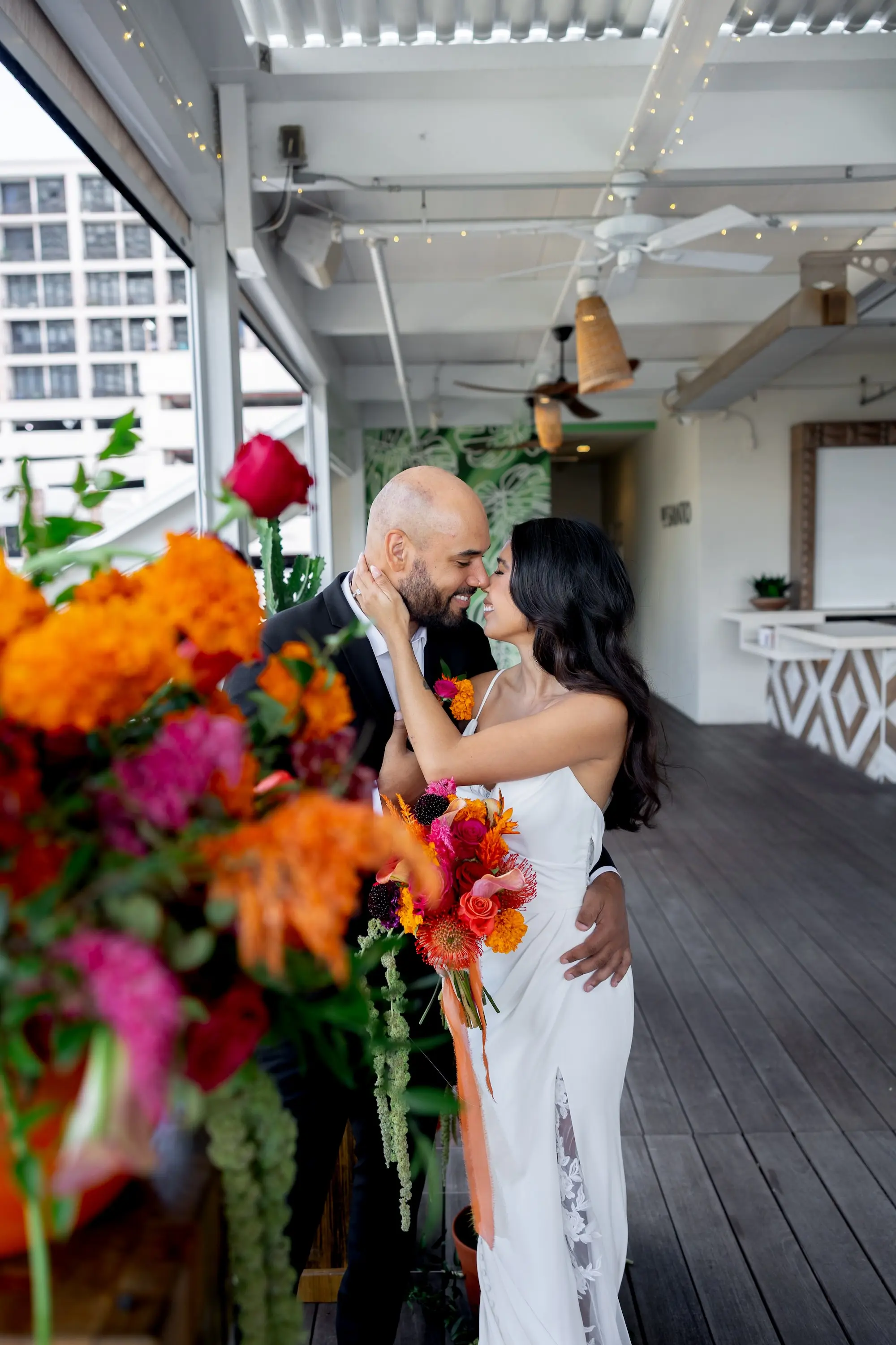 18Vibrant Southwestern Terracotta Pink and Orange Wedding Ideas - Vibrant, Rooftop Wedding Inspiration Shoot | Red Mesa Events Bride and Groom on Balcony Wedding Reception Portrait | Vibrant Southwest Mexican Wedding Reception Ideas | Bright Pink, Orange, Rust Red, Floral Bridal Bouquet Inspiration | White Fitted, Fit and Flare Wedding Gown with Front Slit with Lace Ideas | Soft Curled Hair with Natural Glam Makeup Inspiration | Tampa Bay Florist Save The Date Florida | Tampa Bay Photographer Pine and Forge Photography | Tampa Bay Boutique Truly Forever Bridal | Sarasota Hair and Makeup Artist Femme Akoi Beauty Studio | Content Creator Behind The Vows