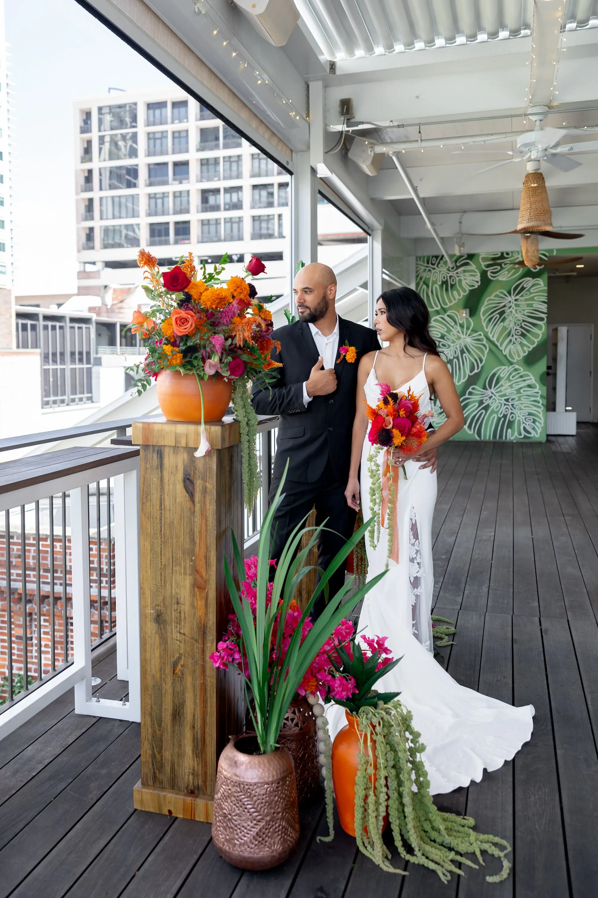 21Vibrant Southwestern Terracotta Pink and Orange Wedding Ideas - Vibrant, Rooftop Wedding Inspiration Shoot | Red Mesa Events Bride and Groom Wedding Reception Portrait | Vibrant Southwest Mexican Wedding Reception Ideas | Bright Pink, Orange, Rust Red, Floral Arrangements with Lush Green Succulents and Cacti Greenery Arrangement Reception Decoration Inspiration | Terracotta Pots Decor Ideas | Soft Curled Down Bridal Hair Inspiration | Tampa Bay Florist Save The Date Florida | St Pete Event Planner Coastal Coordinating | Tampa Bay Photographer Pine and Forge Photography | Downtown St Pete Event Venue Red Mesa Events | Sarasota Hair and Makeup Artist Femme Akoi Beauty Studio | Content Creator Behind The Vows