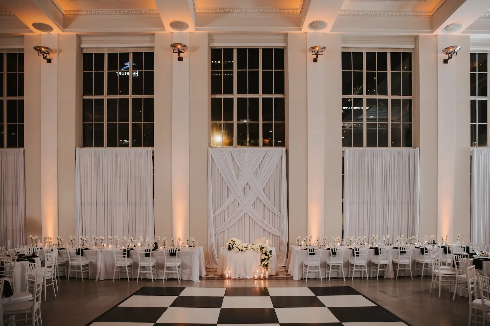 26Modern Black and White Wedding Inspiration Tampa Venue The Vault - Timeless Black and White Downtown Tampa Wedding | The Vault Timeless Black and White Ballroom Wedding Reception | Single Stem White Roses in Bud Vases Centerpieces Ideas | Classic Black and White Dance Floor Inspiration | Romantic Candlelight Tablescape on White Linens Ideas | Black Glass Chargers with Black Napkins and Gold Flatware Decor Inspiration | Tampa Bay Florist Save The Date Florida | Kate Ryan Event Rentals | Venue The Vault
