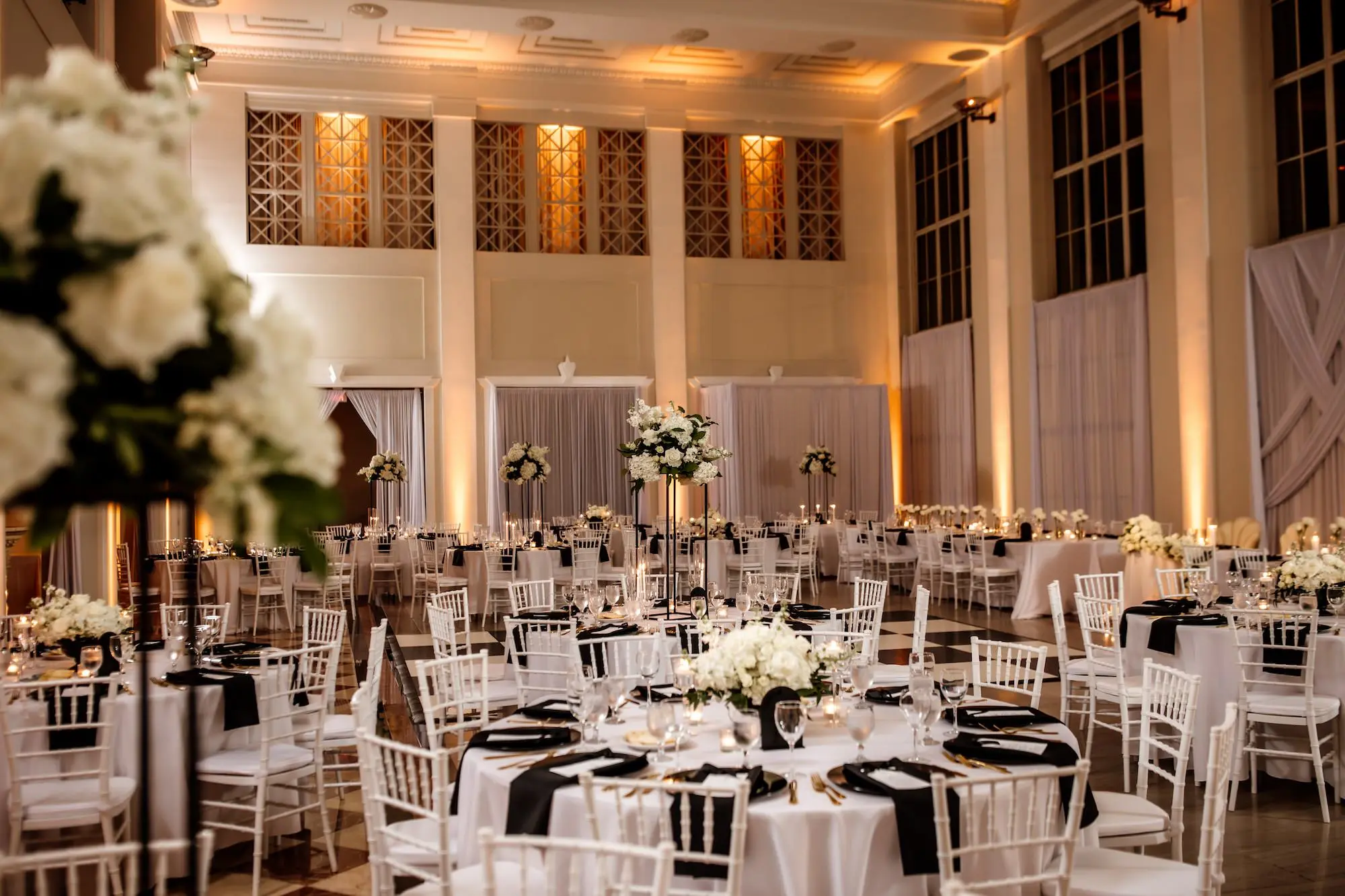 28Modern Black and White Wedding Inspiration Tampa Venue The Vault - Timeless Black and White Downtown Tampa Wedding | The Vault Luxurious Black and White Ballroom Wedding Reception | White Floral and Greenery Centerpieces Inspiration | Romantic Candlelight Tablescape on White Linens Ideas | Black Glass Chargers with Black Napkins and Gold Flatware Decor Inspiration | Tampa Bay Florist Save The Date Florida | Kate Ryan Event Rentals | Venue The Vault