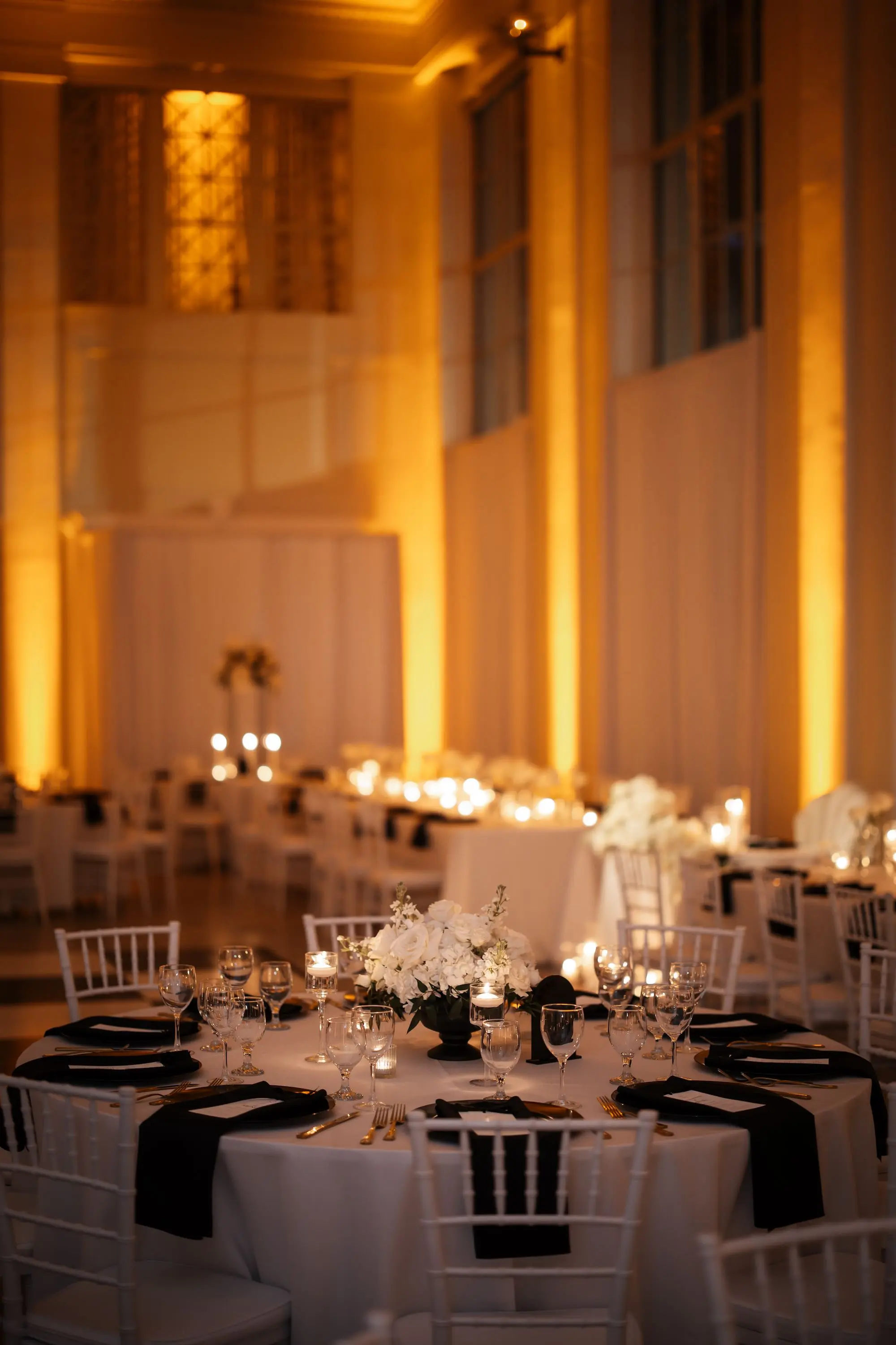 31Modern Black and White Wedding Inspiration - Timeless Black and White Downtown Tampa Wedding | The Vault Luxurious Black and White Ballroom Wedding Reception | White Chiavari Chairs | Short Monochromatic White Florals Centerpieces Inspiration | Romantic Candlelight Tablescape on White Linens Ideas | Black Napkins with Gold Flatware Decor Inspiration | Tampa Bay Florist Save The Date Florida | Kate Ryan Event Rentals | Venue The Vault