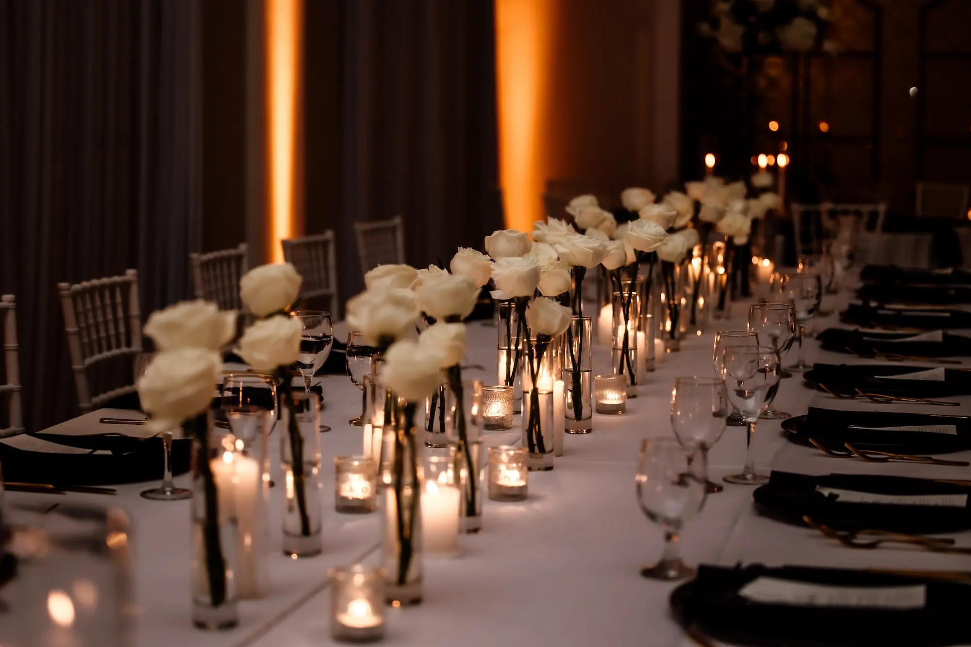 33Modern Black and White Wedding Inspiration - Timeless Black and White Downtown Tampa Wedding | The Vault Timeless Black and White Ballroom Wedding Reception | Single Stem White Roses in Bud Vases Centerpieces Ideas | Romantic Candlelight Tablescape on White Linens Ideas | Black Glass Chargers with Black Napkins and Gold Flatware Decor Inspiration | Tampa Bay Florist Save The Date Florida | Kate Ryan Event Rentals