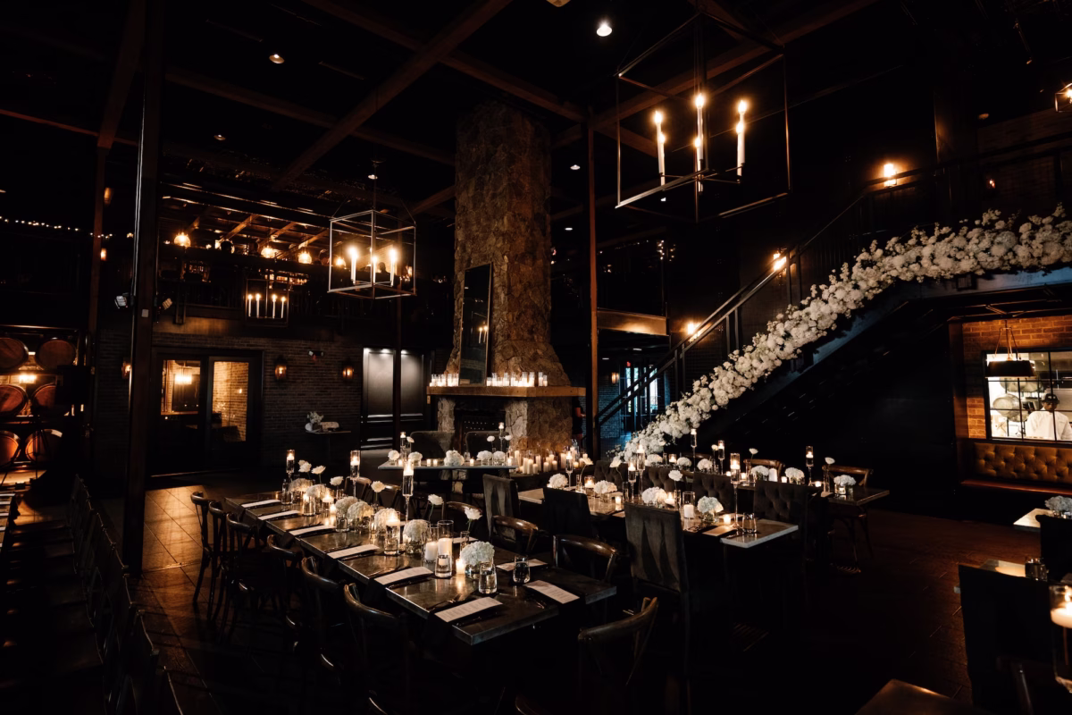 35Dark Black and Moody Candlelight Wedding Inpsiration St Venue Urban StillHouse - Moody, Black St. Pete Wedding | Urban Stillhouse Black and White Dark, Moody Industrial Wedding Reception Decor Inspiration | Romantic Floating Tea Candle Tablescape Reception Decor Ideas | Monochromatic White Roses Short Centerpiece Floral Arrangement Decor Inspiration | St. Petersburg Florida Wedding Reception Venue Urban Stillhouse