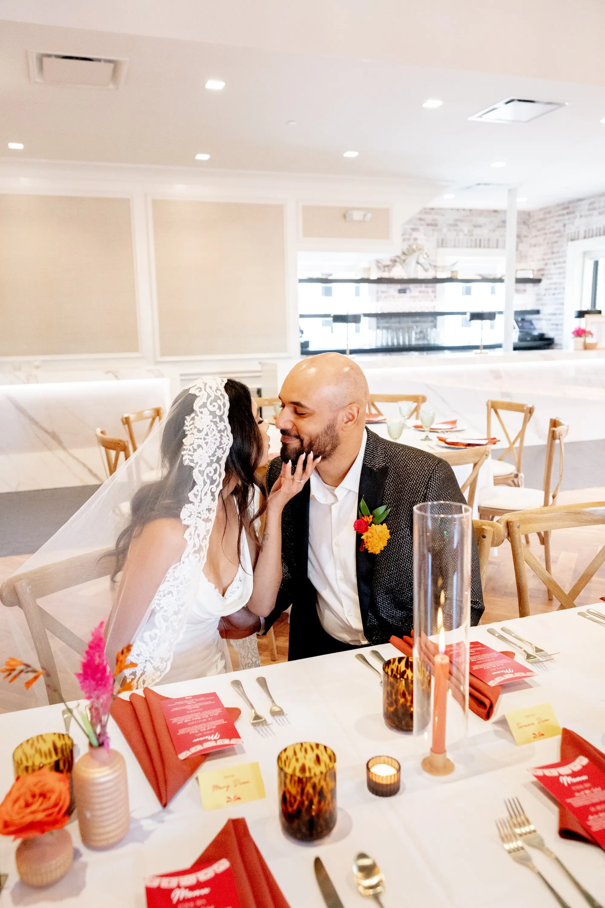 43Vibrant Southwestern Terracotta Pink and Orange Wedding Ideas - Vibrant, Rooftop Wedding Inspiration Shoot | Red Mesa Events Bride and Groom Wedding Reception Portrait | Traditional Mexican Lace Wedding Veil Ideas | Rustic Wooden Chairs | Vibrant Southwest Mexican Wedding Reception Inspiration | Red Acrylic Menus with Red Napkins on White Tablecloth with Romantic Candlelight Tablescape Decor Ideas | St Pete Event Planner Coastal Coordinating | Downtown St Pete Event Venue Red Mesa Events | St Pete Rentals Gabro Event Services