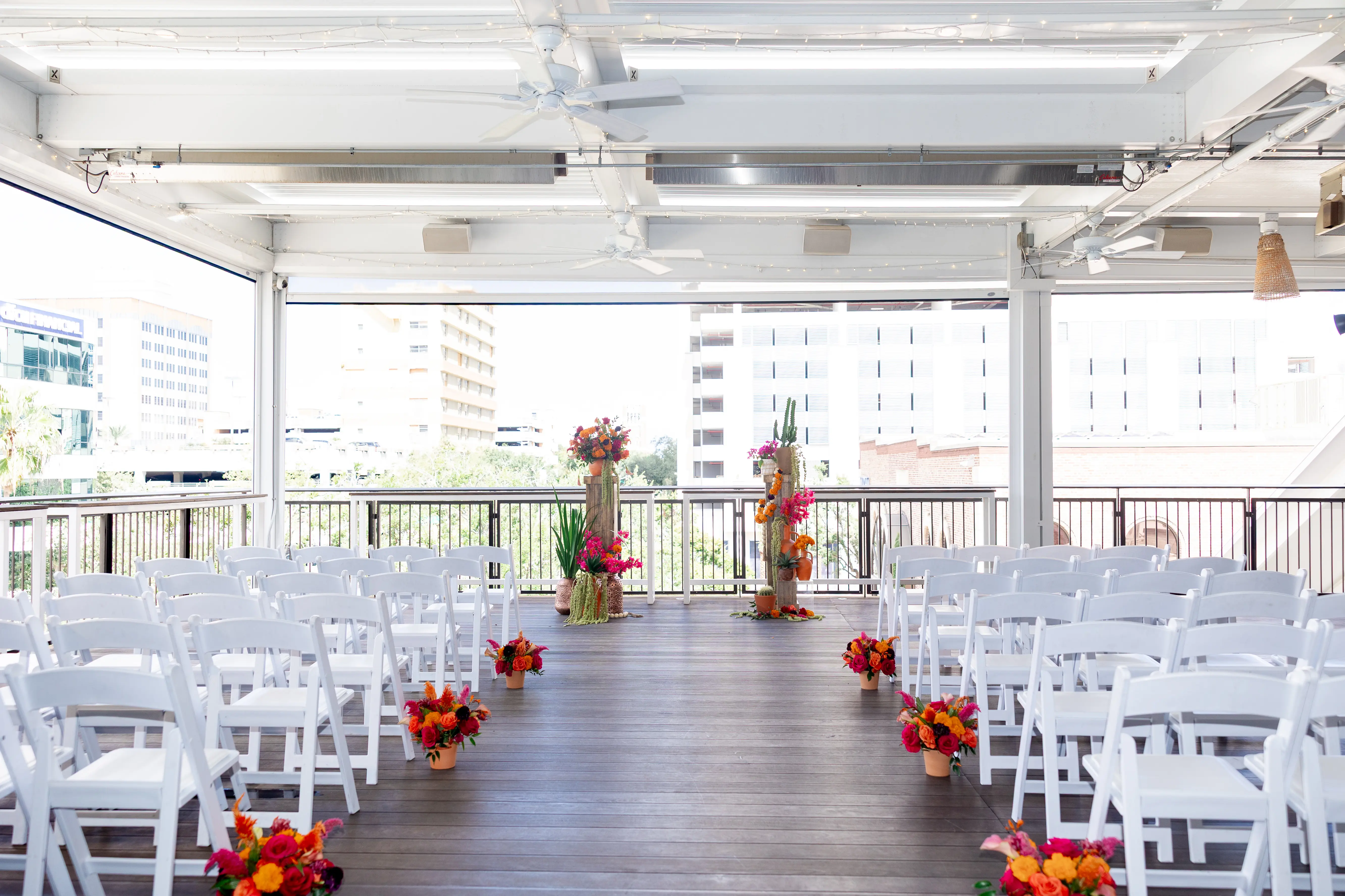 9Vibrant Southwestern Terracotta Pink and Orange Wedding Ideas St Pete Venue Red Mesa Events - Vibrant, Rooftop Wedding Inspiration Shoot | Red Mesa Events Downtown St Pete Vibrant Southwestern Mexican Inspired Balcony Wedding Ceremony Inspiration | White Ceremony Chairs | Bright Pink, Yellow, Red, Orange Floral Arrangements in Terracotta Pots Aisle Decor Ideas | Tampa Bay Florist Save The Date Florida | St Pete Event Planner Coastal Coordinating | Downtown St Pete Event Venue Red Mesa Events