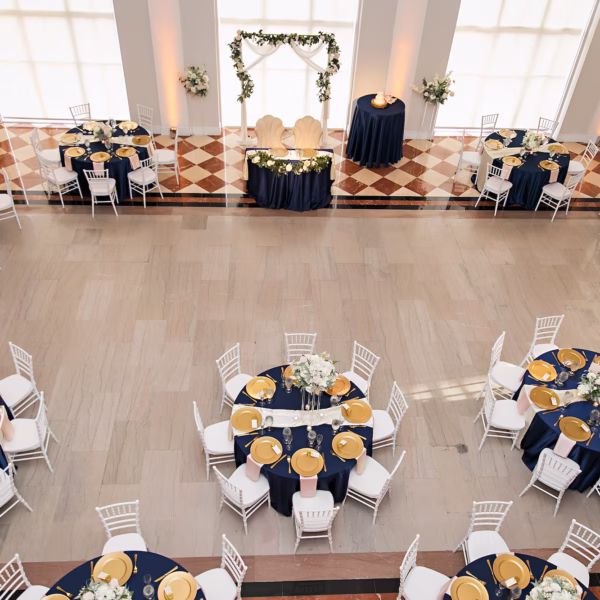 18Elegant Navy Blue and Blush PInk Wedding Ideas Tampa Venue The Vault - Elegant, Navy and Blush Downtown Tampa Wedding | The Vault Old Glam Navy Blue and Blush Pink Winter Wedding Reception Decor Ideas | White and Blush Florals with Greenery Centerpiece Inspiration | Reception Tables with White Chiavari Chairs Ideas | Navy Blue Linens and Gold Chargers and Satin Blush Napkins Reception Tablescape Decor Inspiration | Downtown Tampa Bay Historic Wedding Venue The Vault