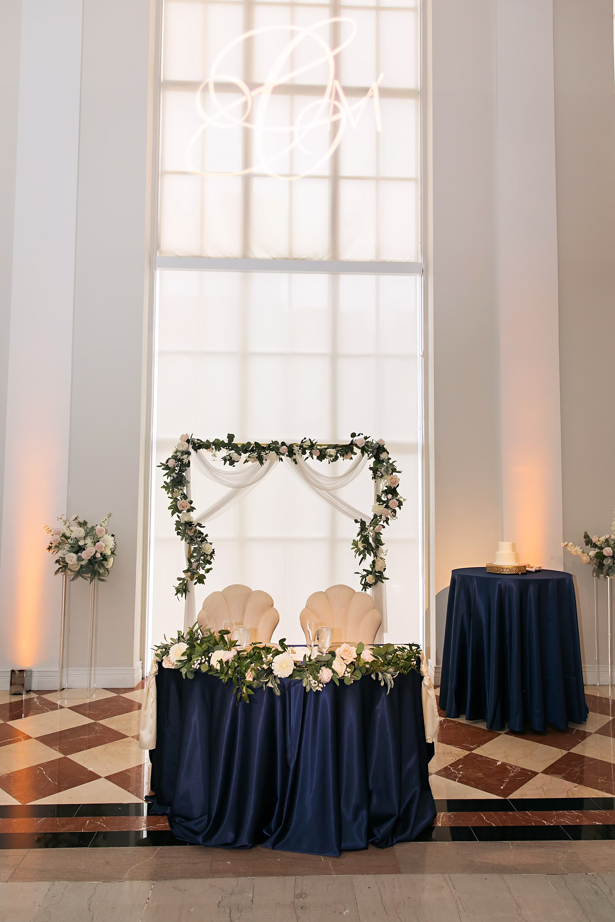 23Elegant Navy Blue and Blush PInk Wedding Ideas - Elegant, Navy and Blush Downtown Tampa Wedding | The Vault Old Glam Navy Blue and Blush Pink Winter Wedding Reception Sweetheart Table Decor Ideas | Square White and Bluse Floral Arch Wedding Reception Decor Inspiration | Navy Blue Linens with White Roses and Eucalyptus Garland Floral Decor Ideas | Tampa Bay Event Venue The Vault