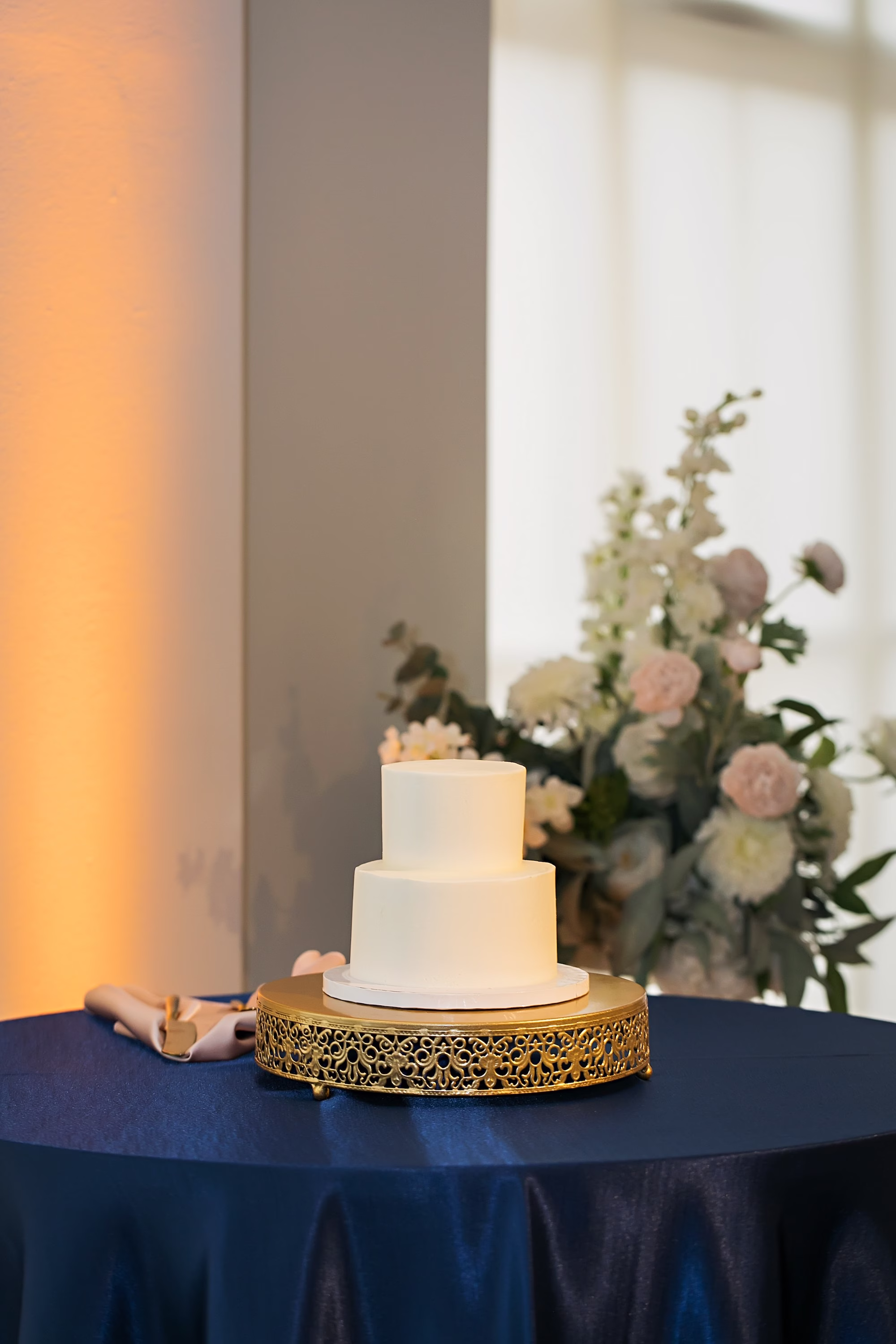 25Elegant Navy Blue and Blush PInk Wedding Ideas - Elegant, Navy and Blush Downtown Tampa Wedding | The Vault Modern Simple Minimalistic Two Tier Wedding Cake on Gold Stand Inspiration | Navy Blue Linens Wedding Reception Decor Ideas