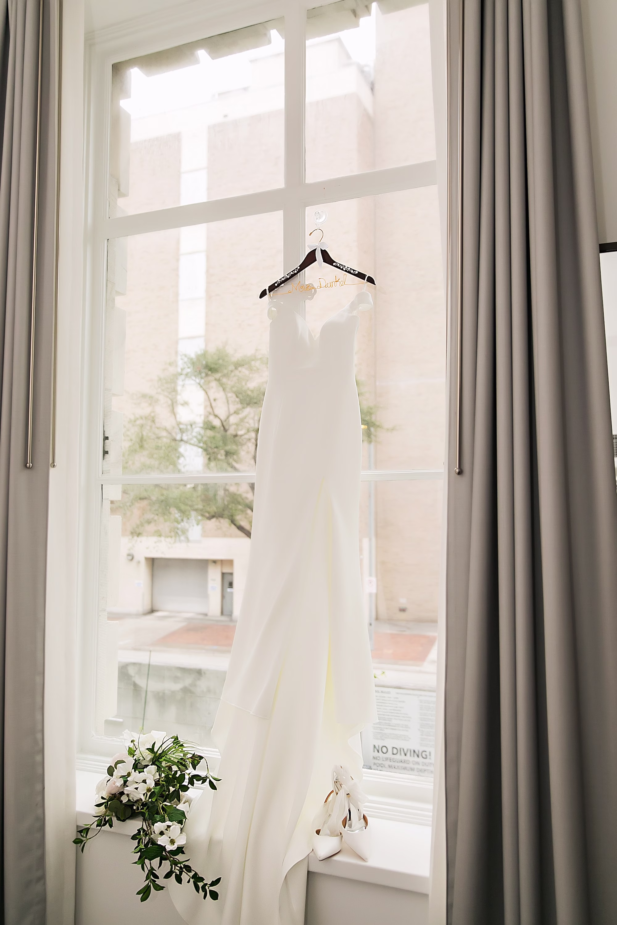 2Elegant Navy Blue and Blush PInk Wedding Ideas - Elegant, Navy and Blush Downtown Tampa Wedding | The Vault White A-Line Stella Grace Wedding Gown hanging in front of Window Ideas | Tampa Bay Photographer Limelight Photography