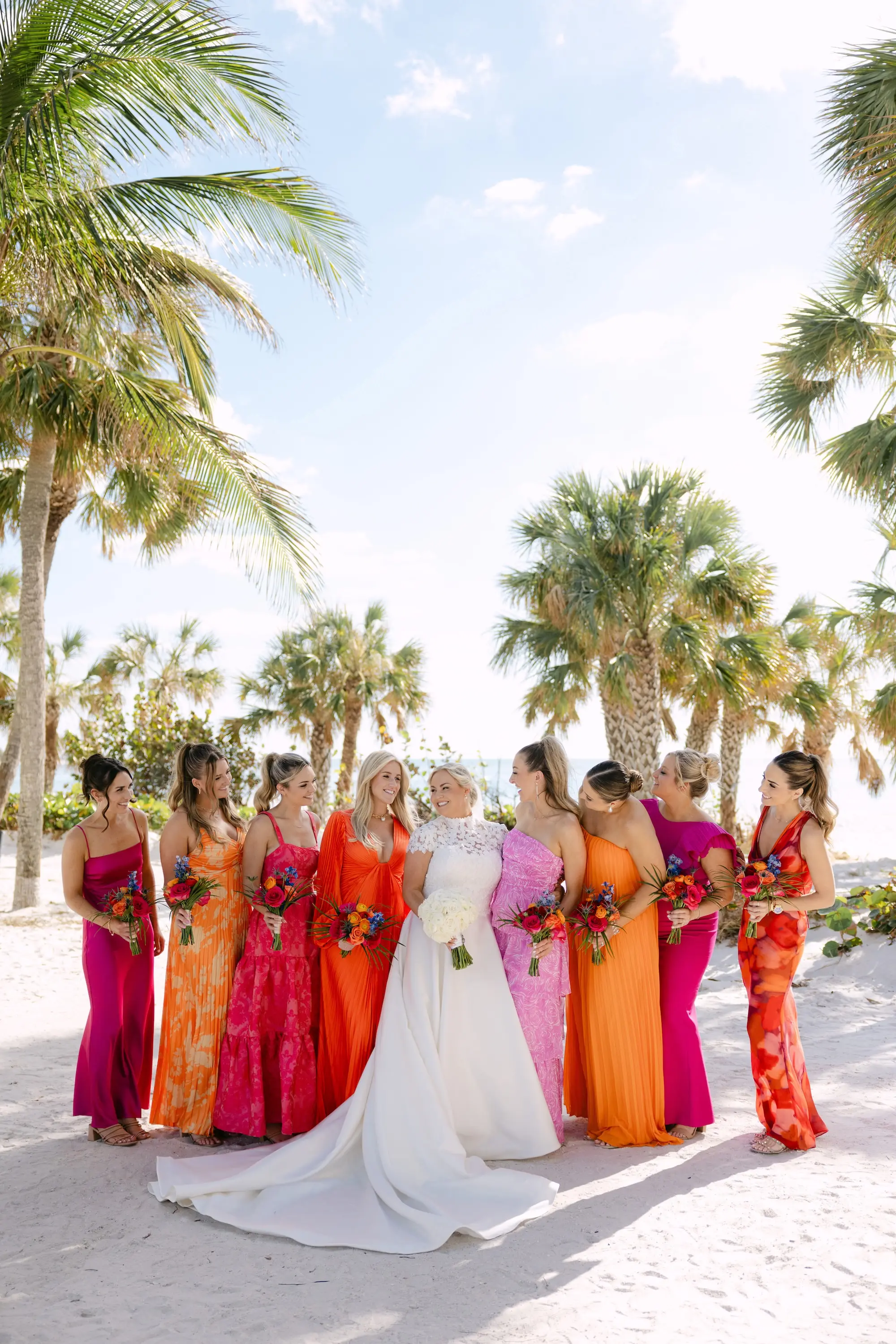 31Tropical Red and Orange Outdoor Florida Destination Wedding Venue Resort and Longoboat Key Club - Tropical Outdoor Sarasota Wedding | The Resort at Longboat Key Club Bride and Bridesmaids Wedding Portrait | Tropical Pink and Orange Mismatched Bridesmaid Dress Inspiration | Sarasota Event Venue The Resort at Longboat Key Club