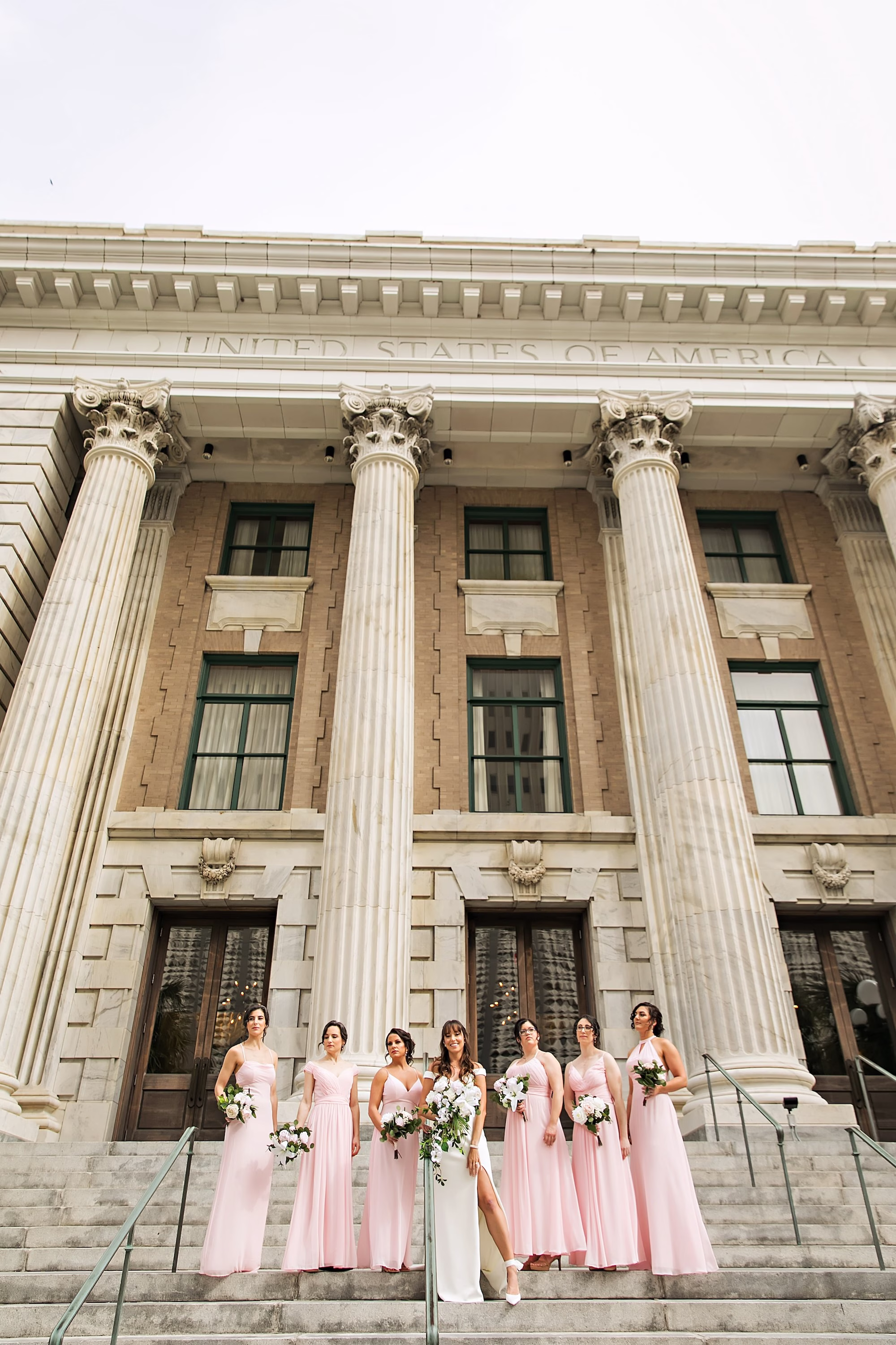 6Elegant Navy Blue and Blush PInk Wedding Ideas - Elegant, Navy and Blush Downtown Tampa Wedding | The Vault Bride and Bridesmaid in front of Historic Downtown Tampa Wedding Venue The Vault | Light Pink Blush Different Style Bridesmaid Dresses Inspiration | White Roses Cascading Bridal Bouquet Ideas | Tampa Bay Photographer Limelight Photography