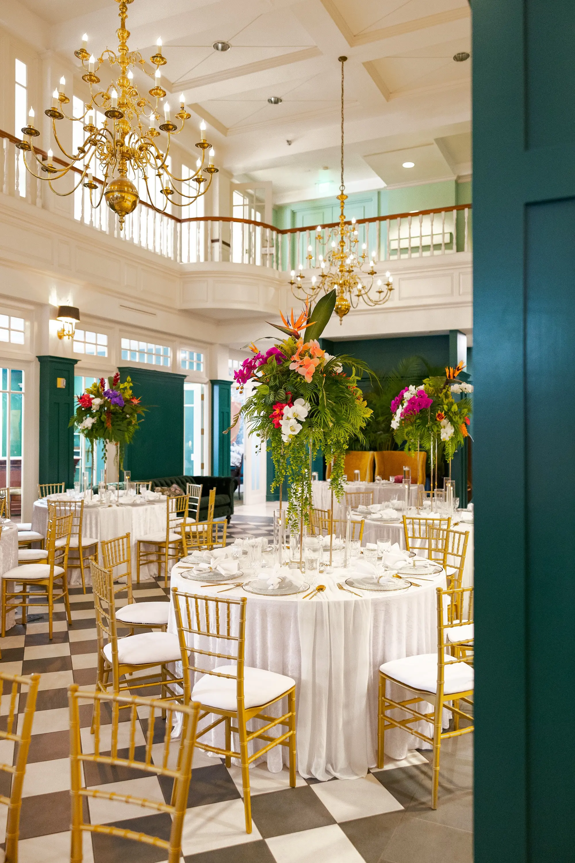 Modern Classic Wedding Ideas | Black and White Checkered Reception Floor Inspiration | White Linens with Gold Chiavari Chairs Ideas | Bright Jewel Toned Coral, Mauves and White Tropical Floral Centerpieces with Deep Green Palms and Greenery Decor Inspiration | Tampa Bay Wedding Venue The Spiral Staircase