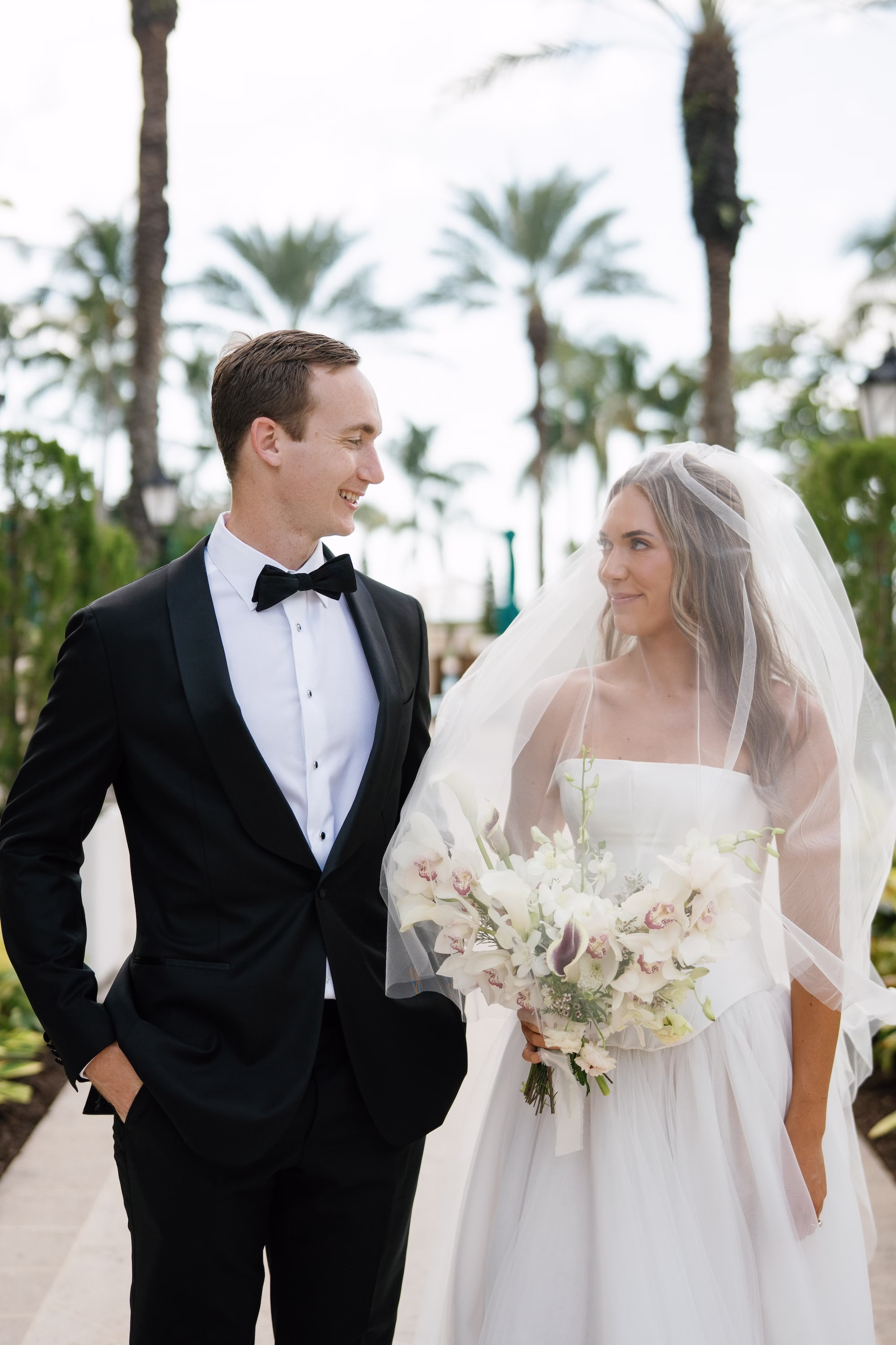 12Elegant Florida Garden Party Wedding Inspiration - Luxurious Garden Destination Wedding | Ritz-Carlton, Sarasota Bride and Groom Wedding Portrait | Groom Class Black and White Tuxedo Attire Inspiration | Traditional Tulle Bridal Veil Ideas | White Orchid Bridal Bouquet Inspiration