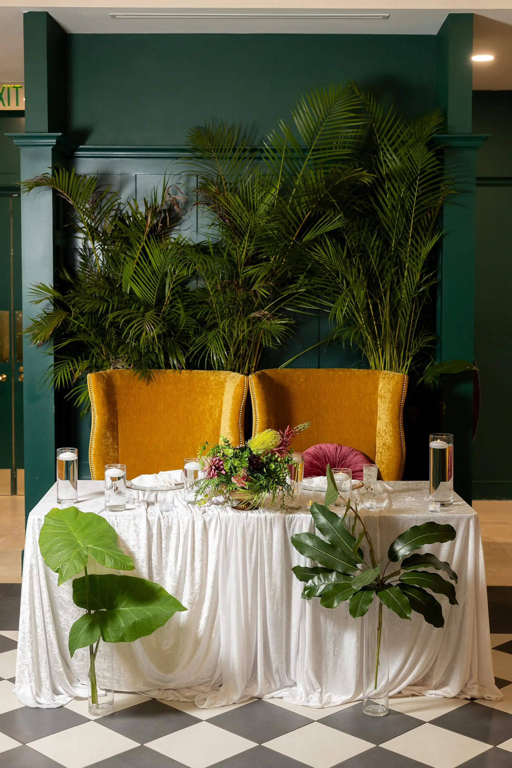 Modern Classic Wedding Inspiration | Bride and Groom on Mustard Yellow Velvet Chairs Sweetheart Table Ideas | Black and White Checkered Reception Floor Inspiration | Tropical Palms Greenery Decor Ideas | Tampa Bay Wedding Venue The Spiral Staircase