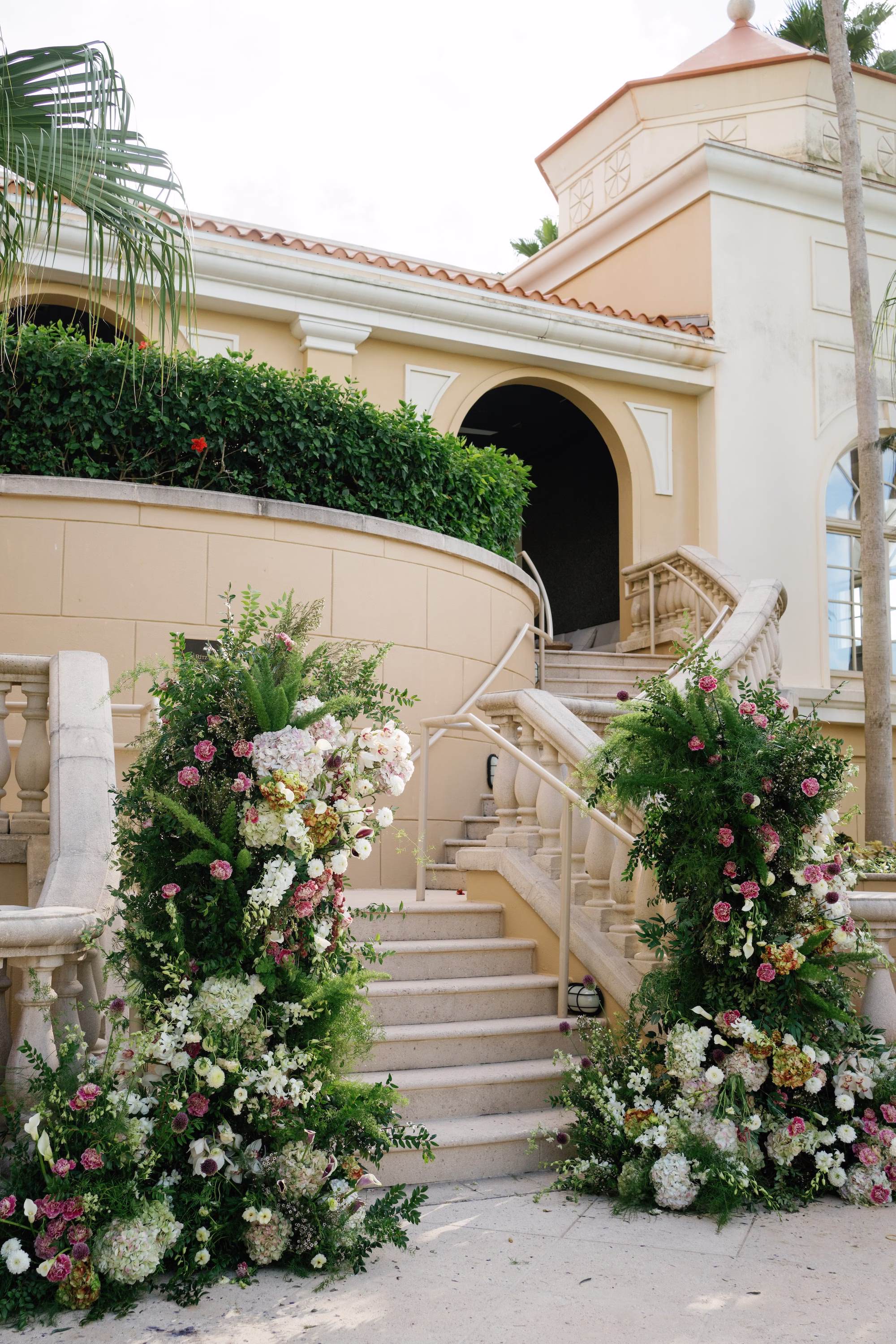 17Elegant Florida Garden Party Wedding Inspiration - Luxurious Garden Destination Wedding | Ritz-Carlton, Sarasota Luxury Outdoor Wedding Ceremony at The Ritz-Carlton Sarasota Inspiration | Lush Asymmetrical Floral Pillars Altar Decor Ideas | Romantic Soft Pink, Mauve, Ivory, Burgundy and White Florals in Greenery Eucalyptus Floral Decor Ideas